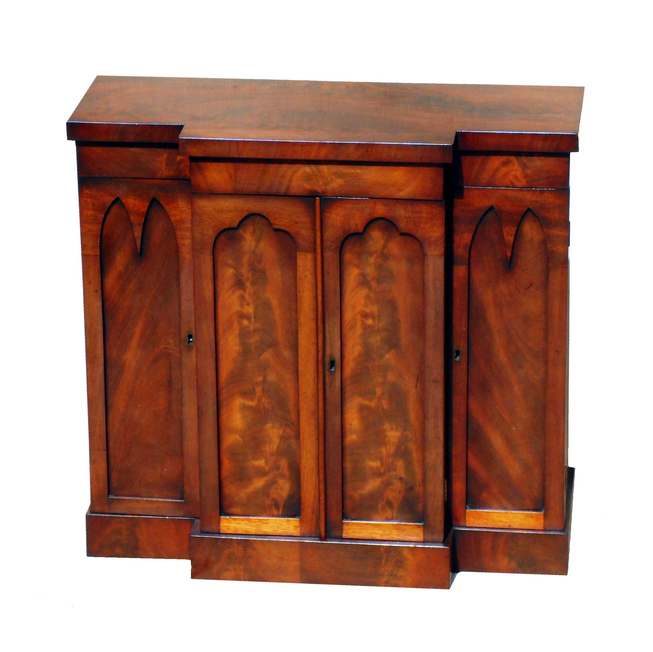 A Very Attractive Mid 19th Century Mahogany Breakfront 
Table Cabinet Having Superbly Figured Top Over Four 
Arched Panelled Doors Raised On Original Plinth Base

(Dating to the mid 19th century this table cabinet is very good
quality and the