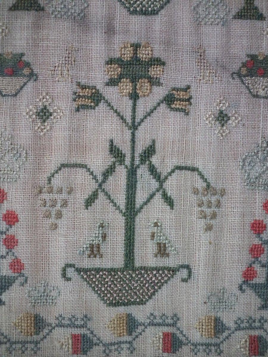 Antique sampler, 1795 by Mary Milligain. The sampler is finely worked in silk on linen ground, in cross stitch and Algerian eye. Meandering strawberry border. Colors green, blue, red, yellow, white, brown and cream. Signed and dated, 'Mary Milligain