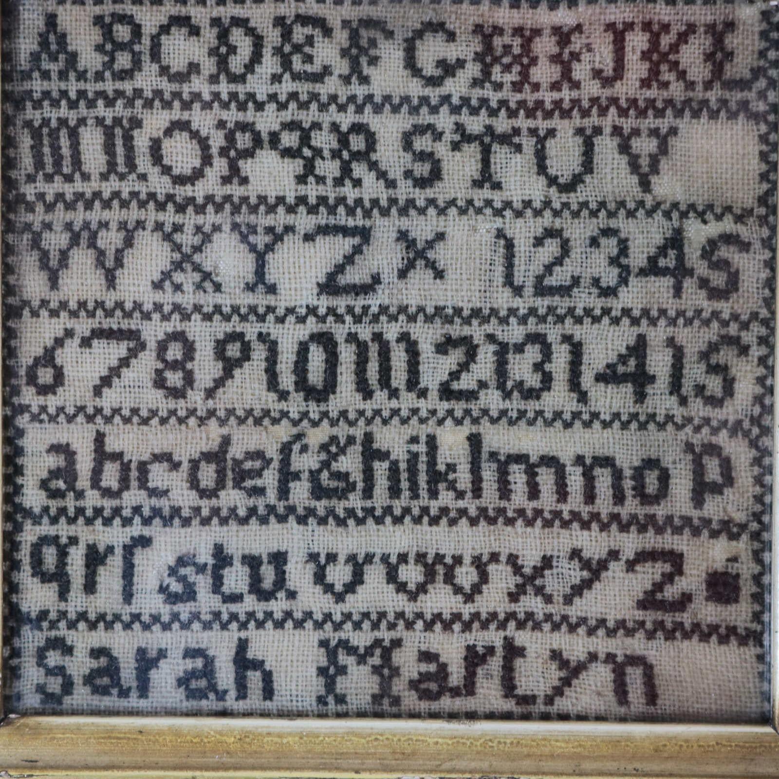 Antique miniature sampler, by Sarah Martyn. The sampler is worked in silk on linen ground, in cross stitch throughout. Simple line border. Black thread throughout. Alphabets A-Z in upper case and lower case and numbers 1-15. Signed 'Sarah Martyn'.