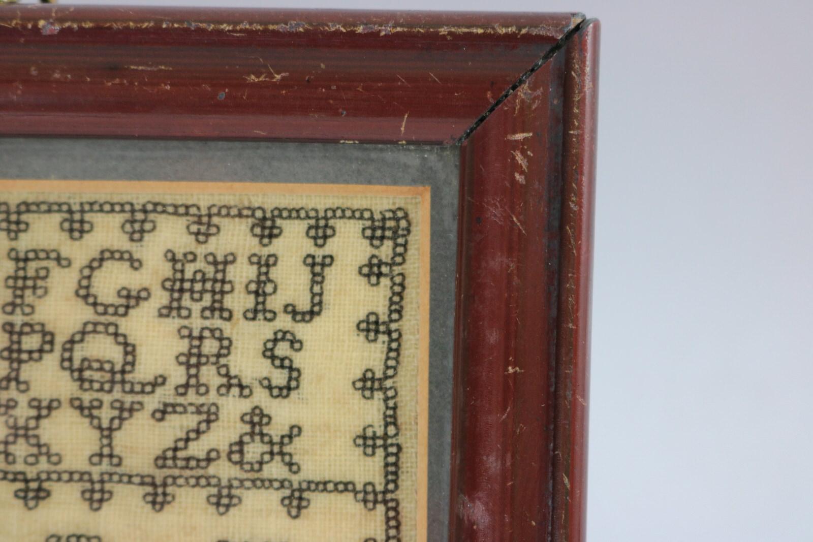 Antique Miniature Sampler, c.1835, with Crowns. The sampler is worked in silk on linen ground. Black thread used throughout. Alphabet A-Z in upper case. Four crown motifs with letters above. Framed in an old wood frame with glass. Mounting: The