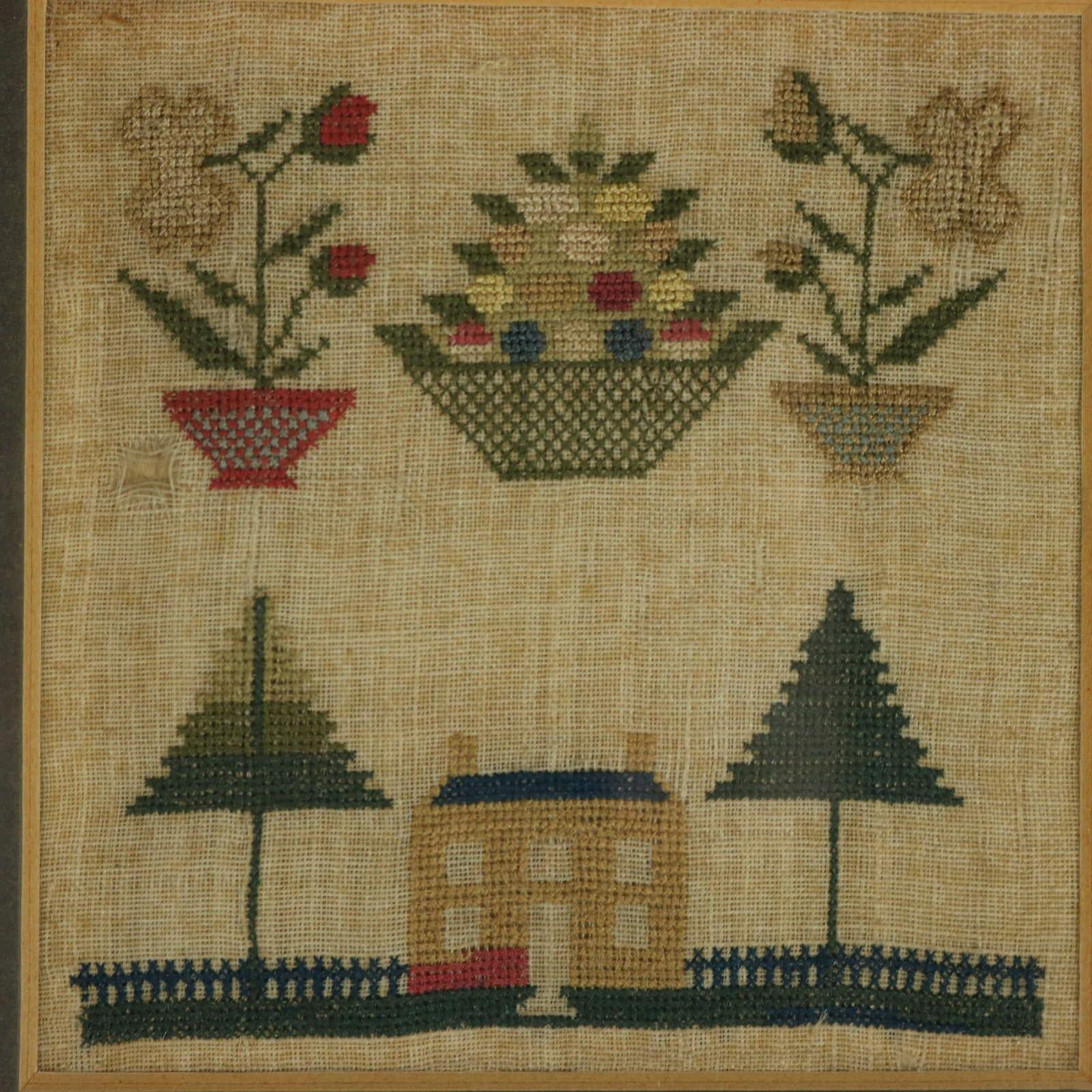 Georgian Miniature Sampler with a House. The sampler is worked in wool and silk threads on a linen ground, mainly in cross stitch. Colours green, yellow, light brown, silver, blue and pink. A scattering of motifs, including a house with fir trees
