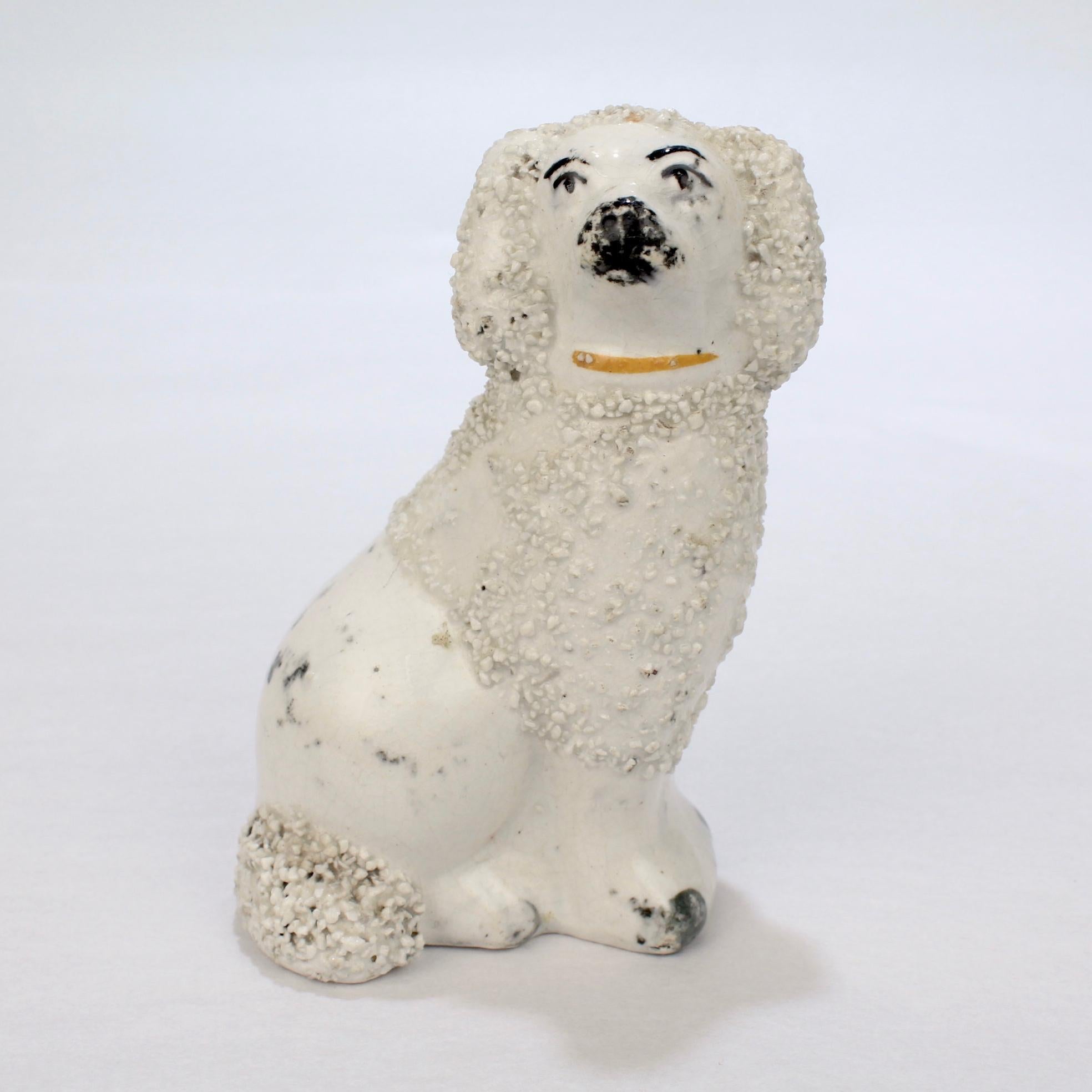 A fine antique English Staffordshire pottery figurine.

Depicting a seated Spaniel.

With confetti fur and painted black highlights.

Simply a wonderful Staffordshire dog figurine!

Date: 
Mid to Late 19th Century

Overall Condition:
It is in