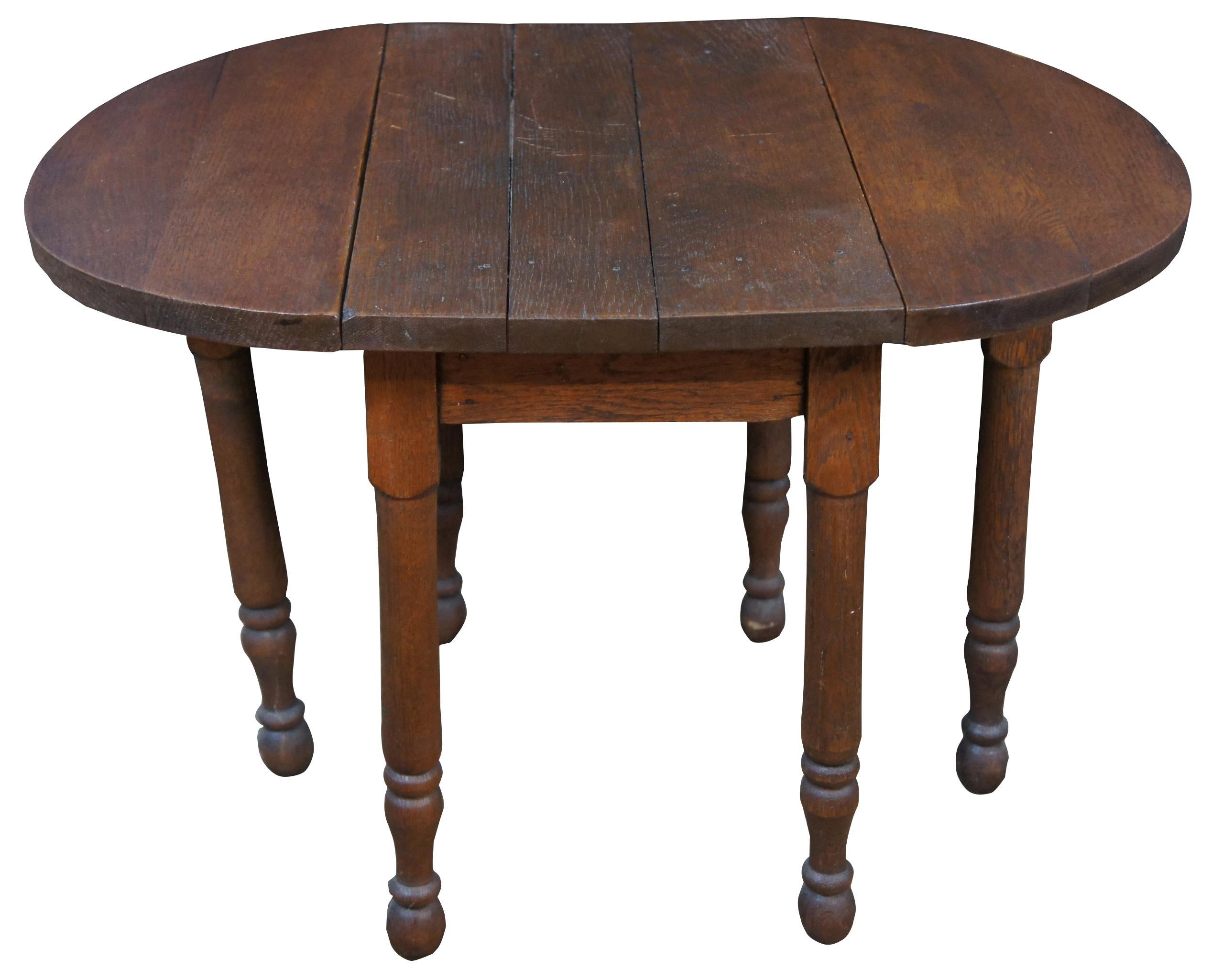 Early 20th century antique Victorian miniature salesman sample drop-leaf gateleg dining table. Features a plank top with oval gateleg extensions. Measures: 18