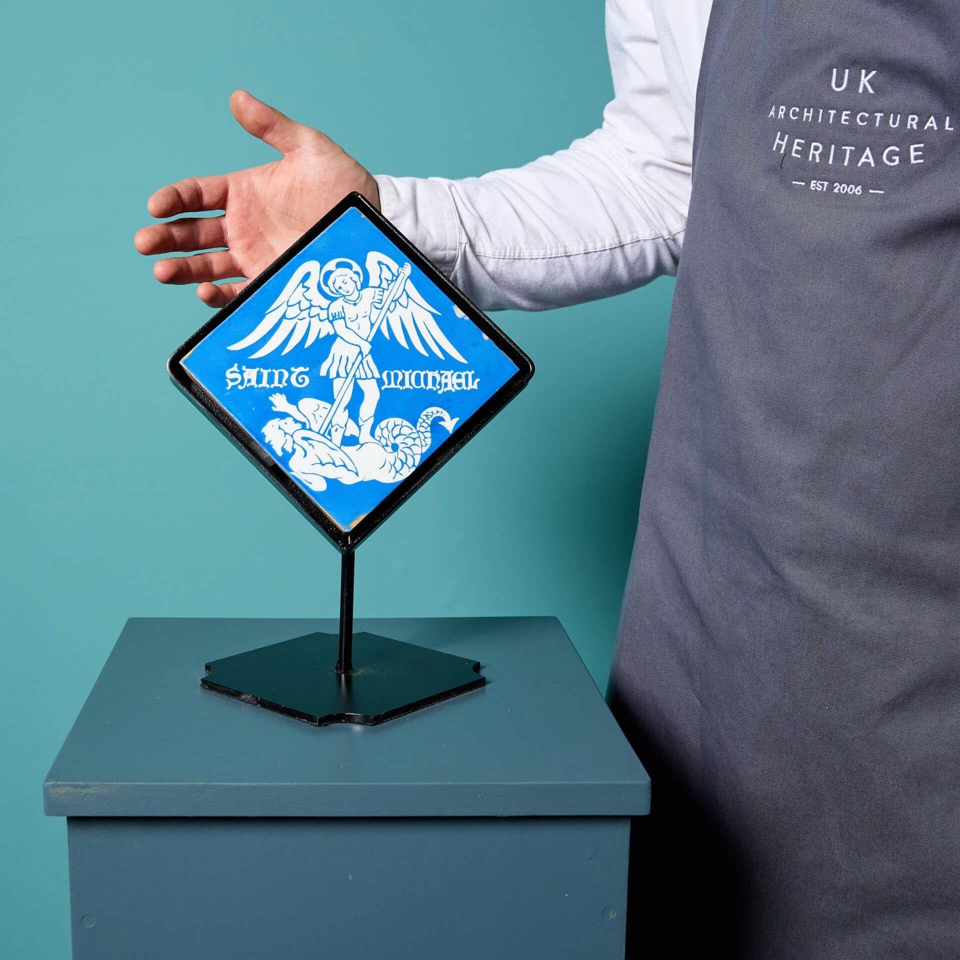 An antique Minton & Co encaustic tile of St Michael.

Dating to circa 1860, the vivid blue glaze accompanied by the bright white emphasises the intriguing scene displayed on this impressive 6-inch tile.
The subtle timeworn look adds character and