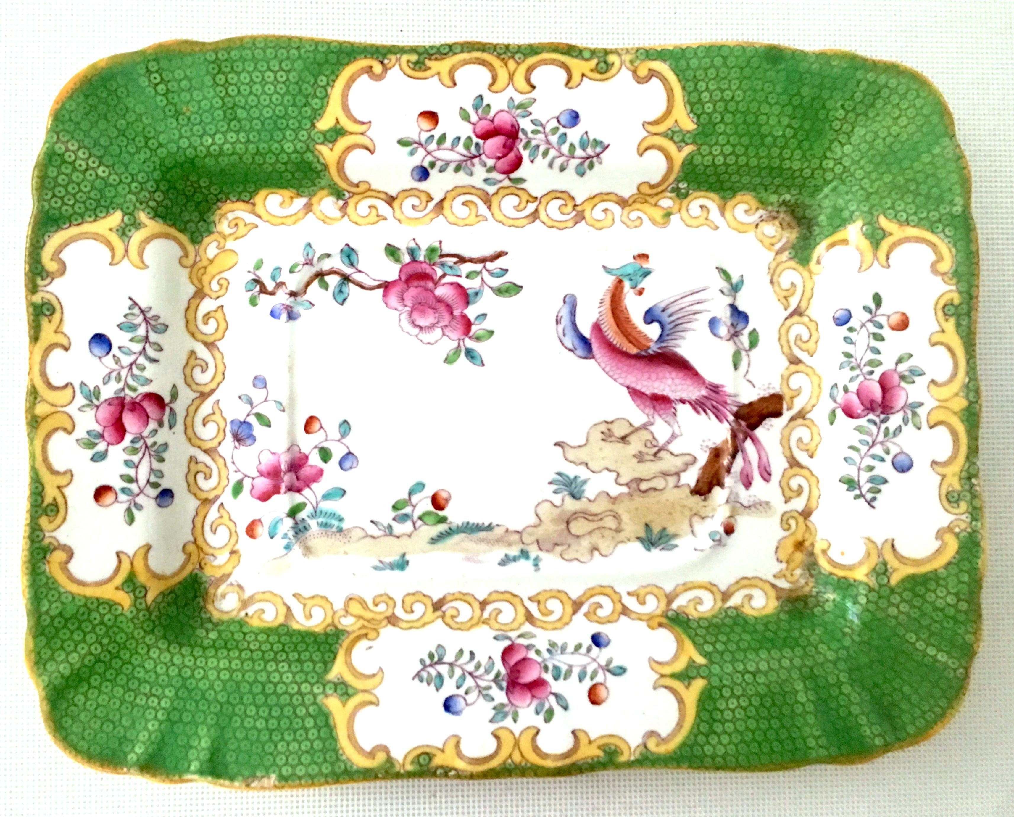 Antique Minton England hand painted porcelain & 22K gold tray's set of 2. These hand painted porcelain trays depict a multi color floral and bird with scroll detail motif. The chartreuse green dimensional dimpled edge is accented with a 22K gold