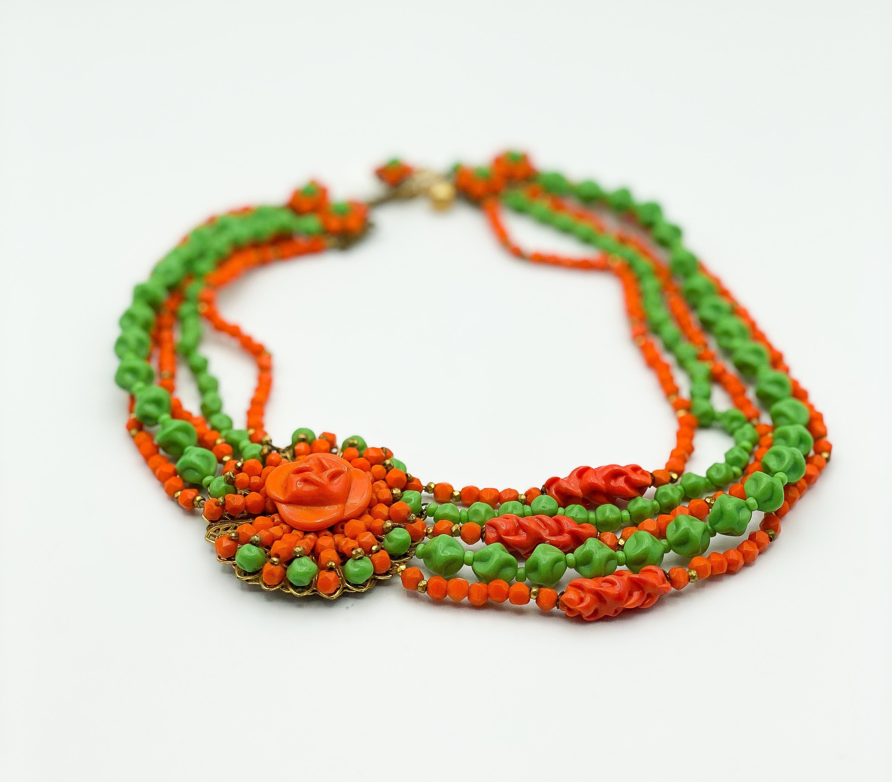 Antique Miriam Haskel design, 

Beaded Orange & Green necklace with brooch-style, offset, pendant, 

Approximately 16 inches in length (not including extension chain) 