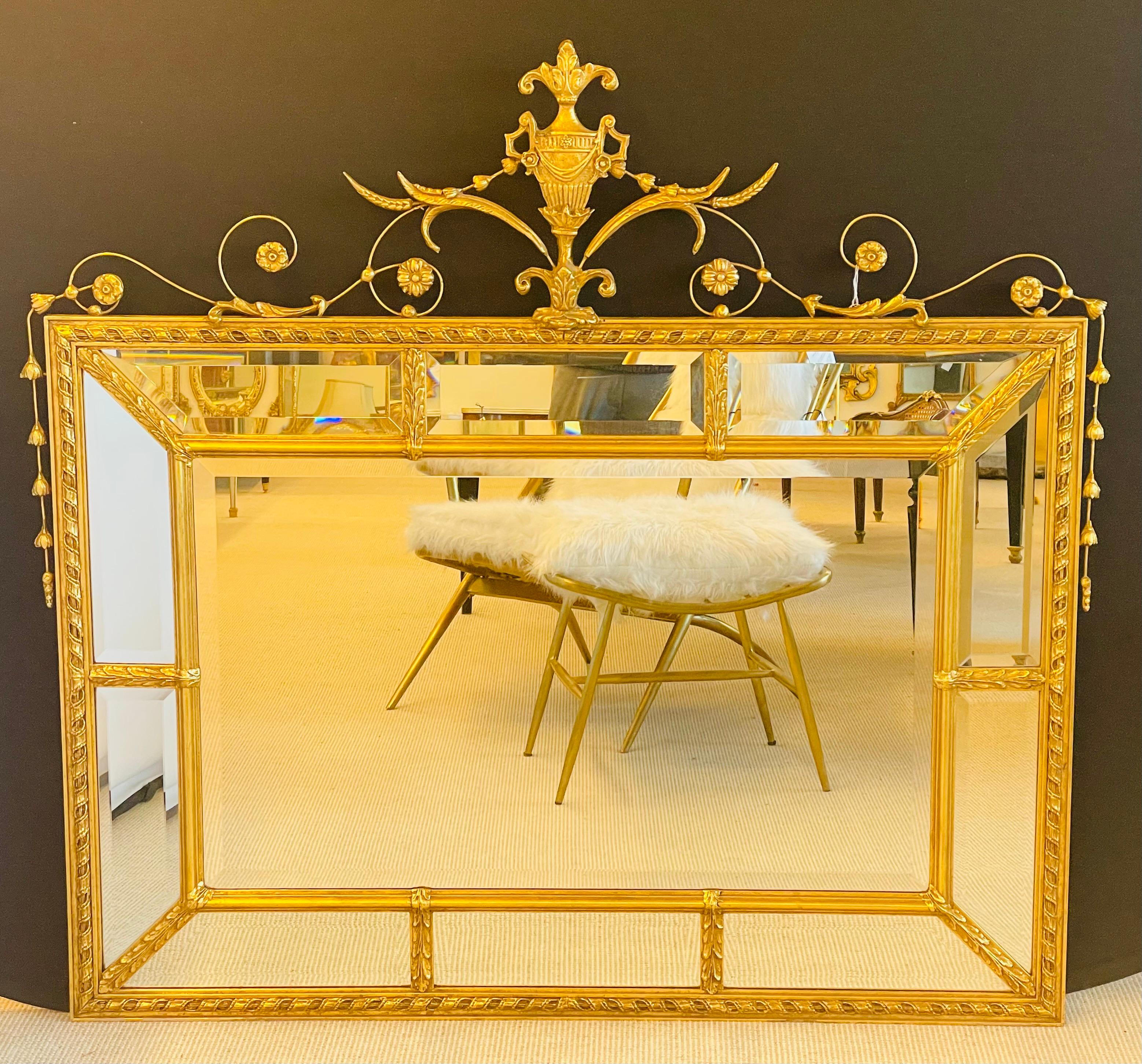 Adams style wall or console mirror. A finely carved wall or console, over the mantle mirror. The center beveled mirror flanked by a group of ten framed beveled mirrors set in gilt wood design. The top having an intricately pierced carved array of