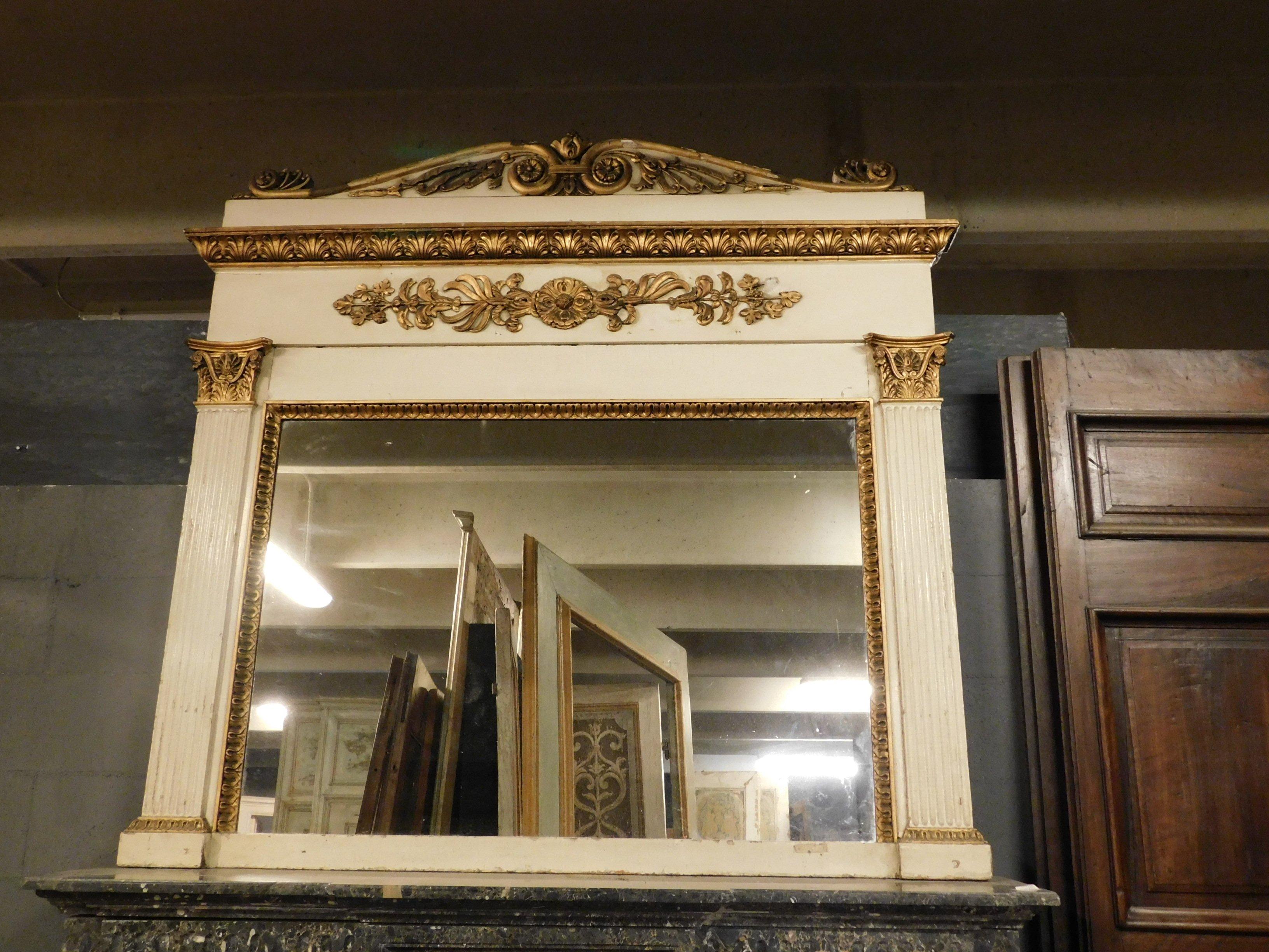 Antique mirror in carved wood with columns and period friezes, ivory lacquered with golden decorations, hand carved and lacquered in the first half of the 19th century, for an important Italian palace.
Mirror that was born as a mirror above a