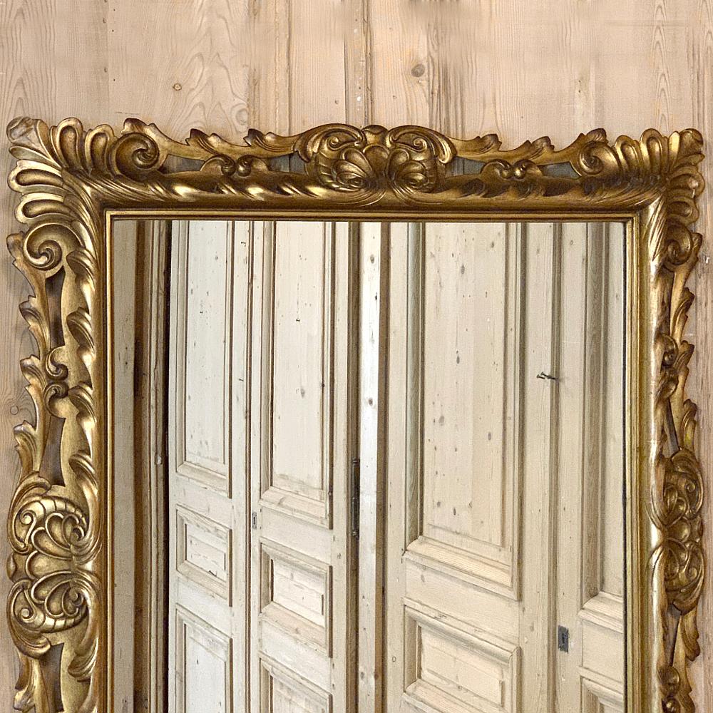 Antique Italian giltwood mirror displays remarkable detail in the carved embellishment that surrounds the entire frame, designed in such a way that it can be mounted vertically or horizontally to make it as versatile as it is beautiful to behold!