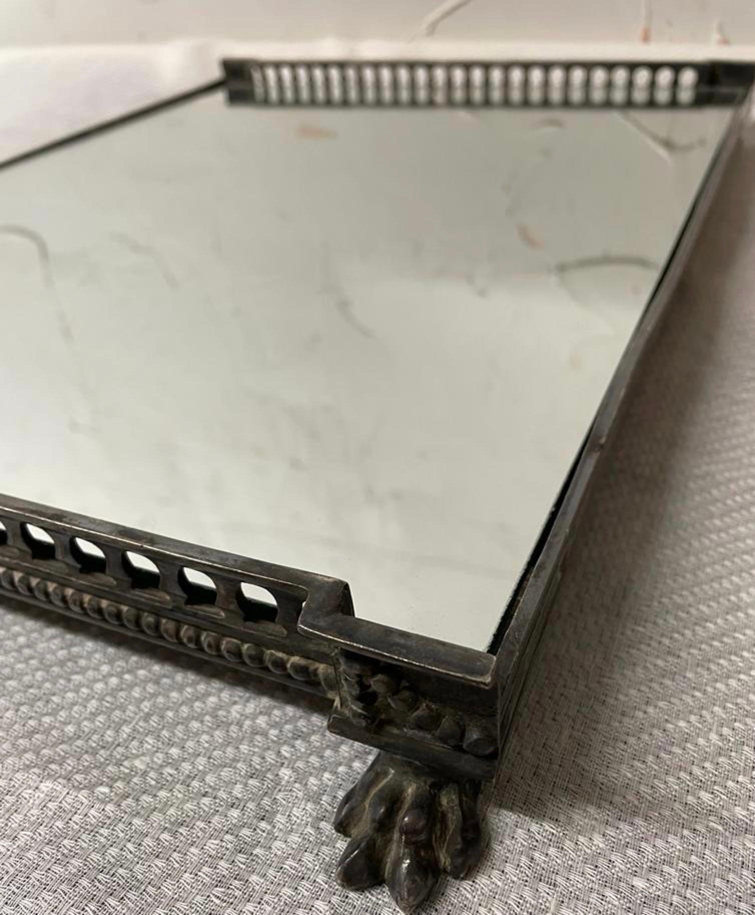 A fine Edwardian style gallery silver plated serving tray with mirrored insert backed by wood.
The tray is supported by 4 paw feet adding extra style and character.
OFFERING FREE SHIPPING WITHIN US CONTINENT.  PLEASE JUST ASK FOR SHIPPING QUOTE.
