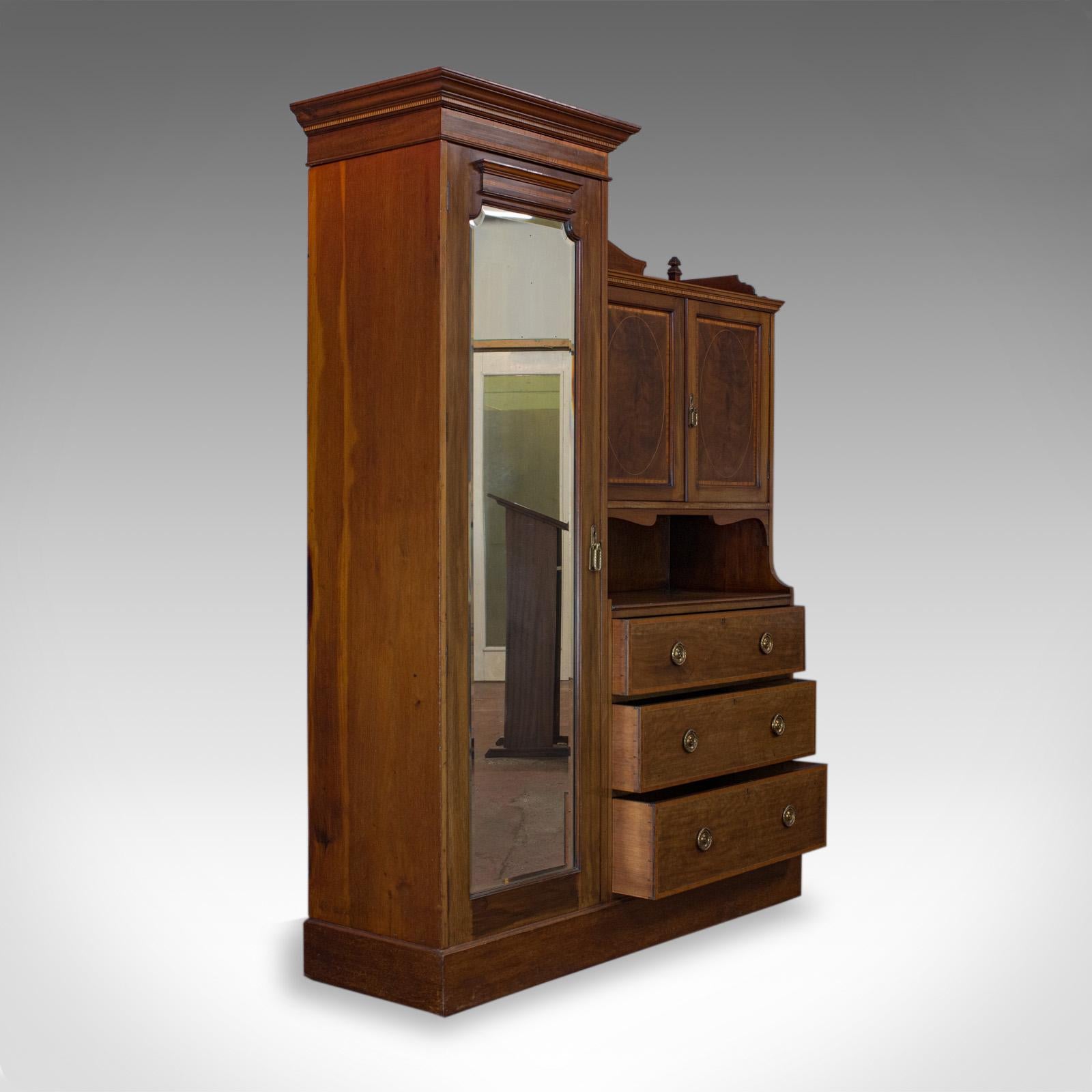 This is an antique mirrored wardrobe. An English, Edwardian, mahogany compactum darting to the early 20th century, circa 1910.

Select mahogany displays rich, russet hues
Attractive grain interest and a desirable aged patina
Deep crown moulding