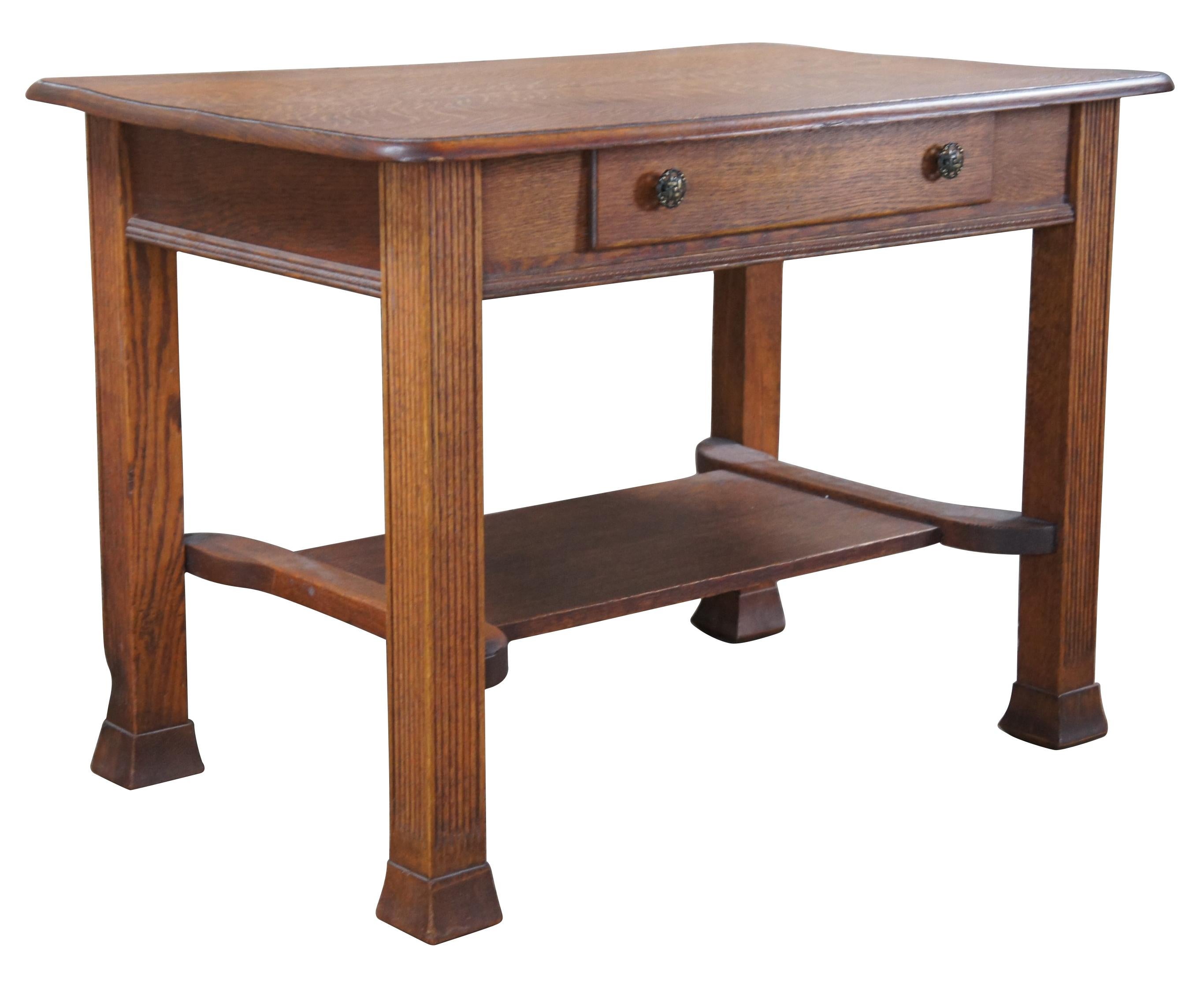 A beautiful early 20th century oak desk. Features a rectangular frame with central dovetailed drawer accented by brass filigree hardware over an egg and drat carved molding.  The desk is supported by square fluted legs leading to flared feet.  A