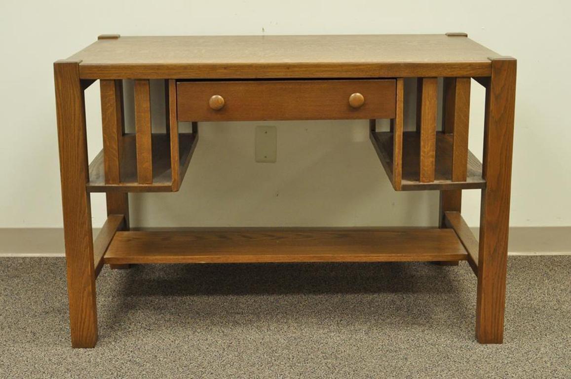 Antique Mission Arts & Crafts solid oak writing desk. Item features solid quartersawn oakwood construction, lower tier, single rabbet joint and nail constructed drawer, open slatted bookcase sides. I was told that the original owners had the item