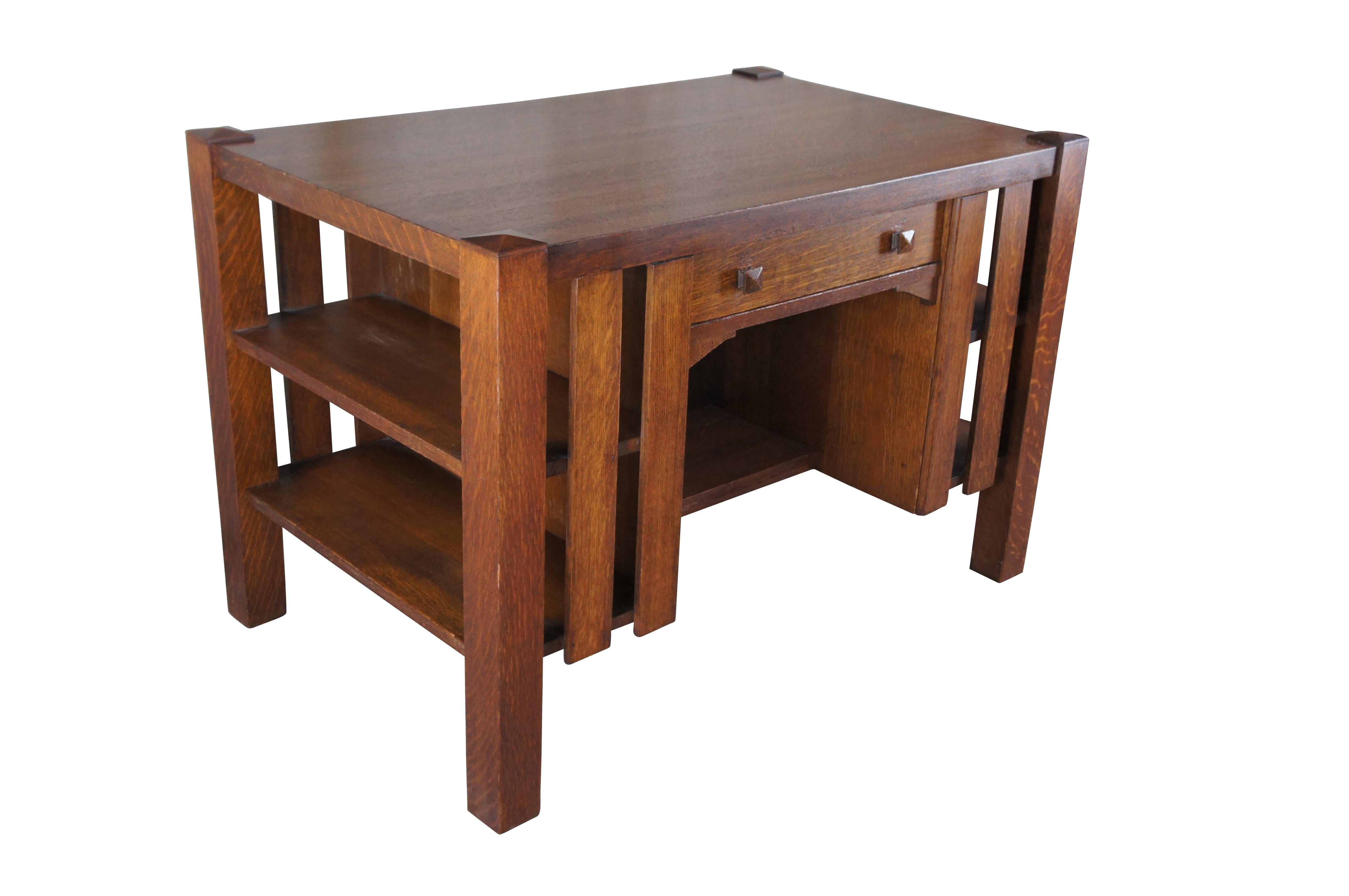 An early 20th Century Mission / Arts & Crafts / Craftsman library table.  Features a rectangular form made from quartersawn oak with a dovetailed drawer flanked by bookshelves on the outside.  The desk is finished on all sides allowing for use in