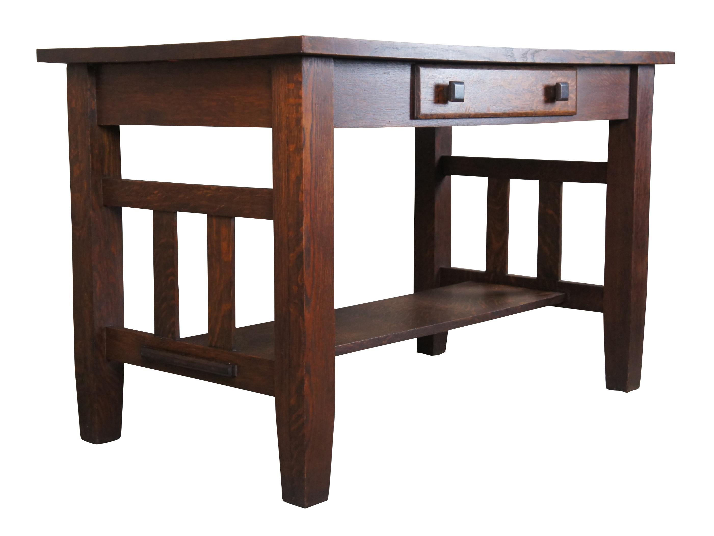 Antique handmade Mission desk made by James Dietz an Ohio craftsman, circa 1920s. A rectangular form made from quartersawn oak with classic slatted sides and lower shelf / foot rest. Includes a central drawer with square turned pulls.