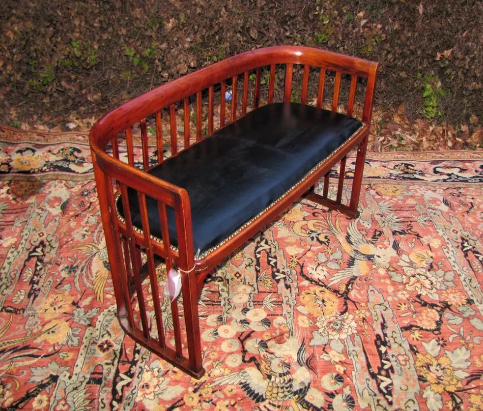 This is an antique Josef Hoffmann settee from the early 1900s in very good condition, with no repairs or replaced parts. Josef Hoffmann, an artist from Vienna, Austria, designed these barrel chairs in the 1920s.  The table is 45