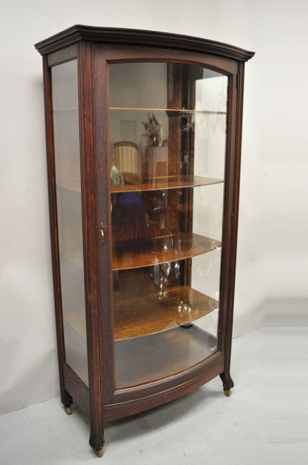 Antique Mission Oak Arts & Crafts bowed front China Display cabinet Curio. Item features front door with bowed plexiglass panel, side panels are glass, rolling casters, beautiful wood grain, 4 adjustable shelves, working lock and key, very nice