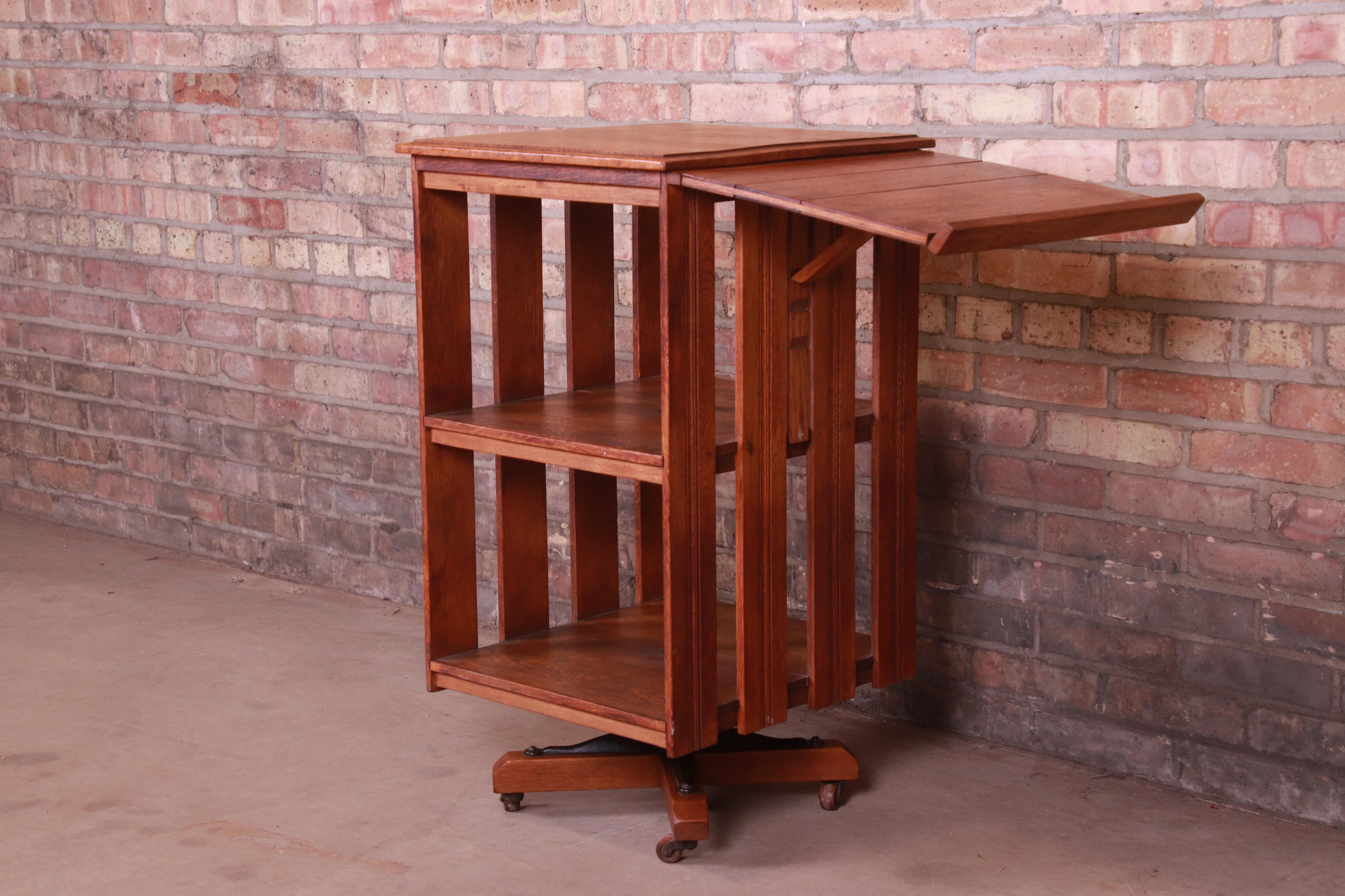 A gorgeous antique mission oak Arts & Crafts revolving bookcase with fold-up reading stand,

circa 1900

Measures: 17.38