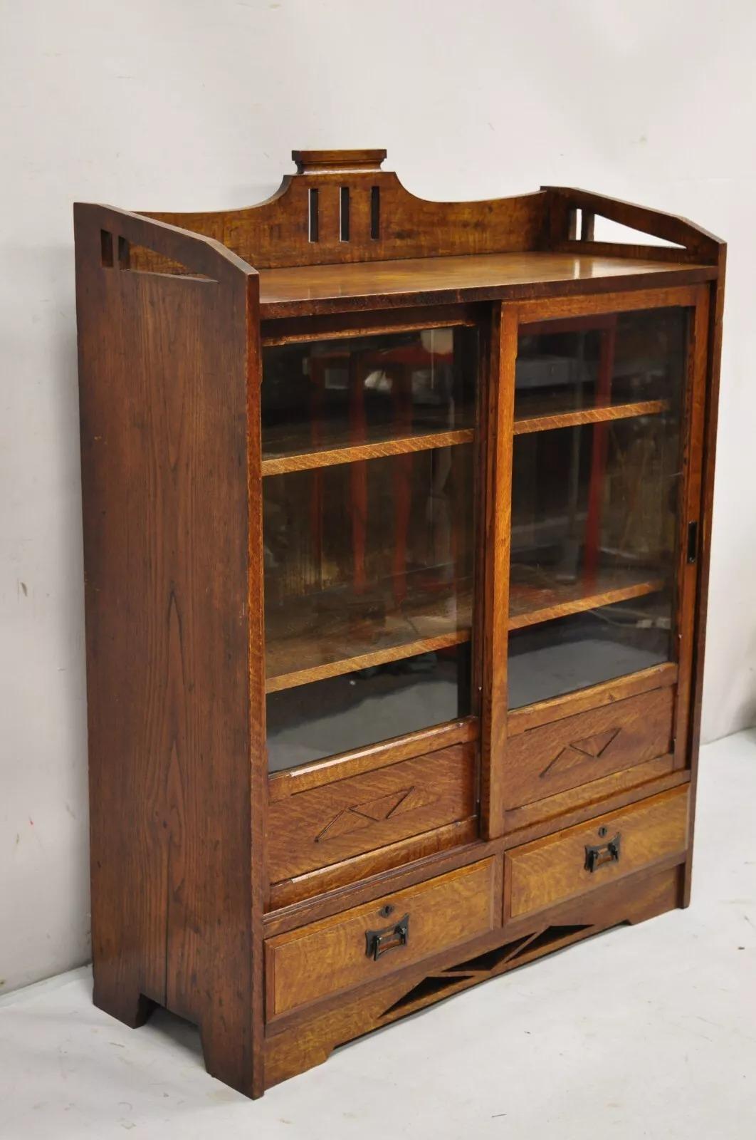 Antique Mission Oak Arts & Crafts Small Sliding Door Bookcase Curio with Drawers. Circa Early 20th Century. Measurements: 42.5