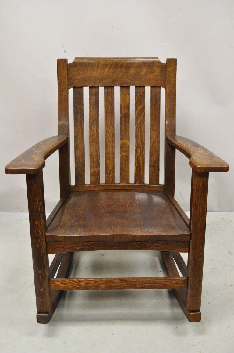 Antique mission oak Arts & Crafts stickley style rocker rocking chair. Item features a solid oak wood frame, beautiful wood grain, very nice antique item, quality American craftsmanship. circa early 1900s. Measurements: 35.5