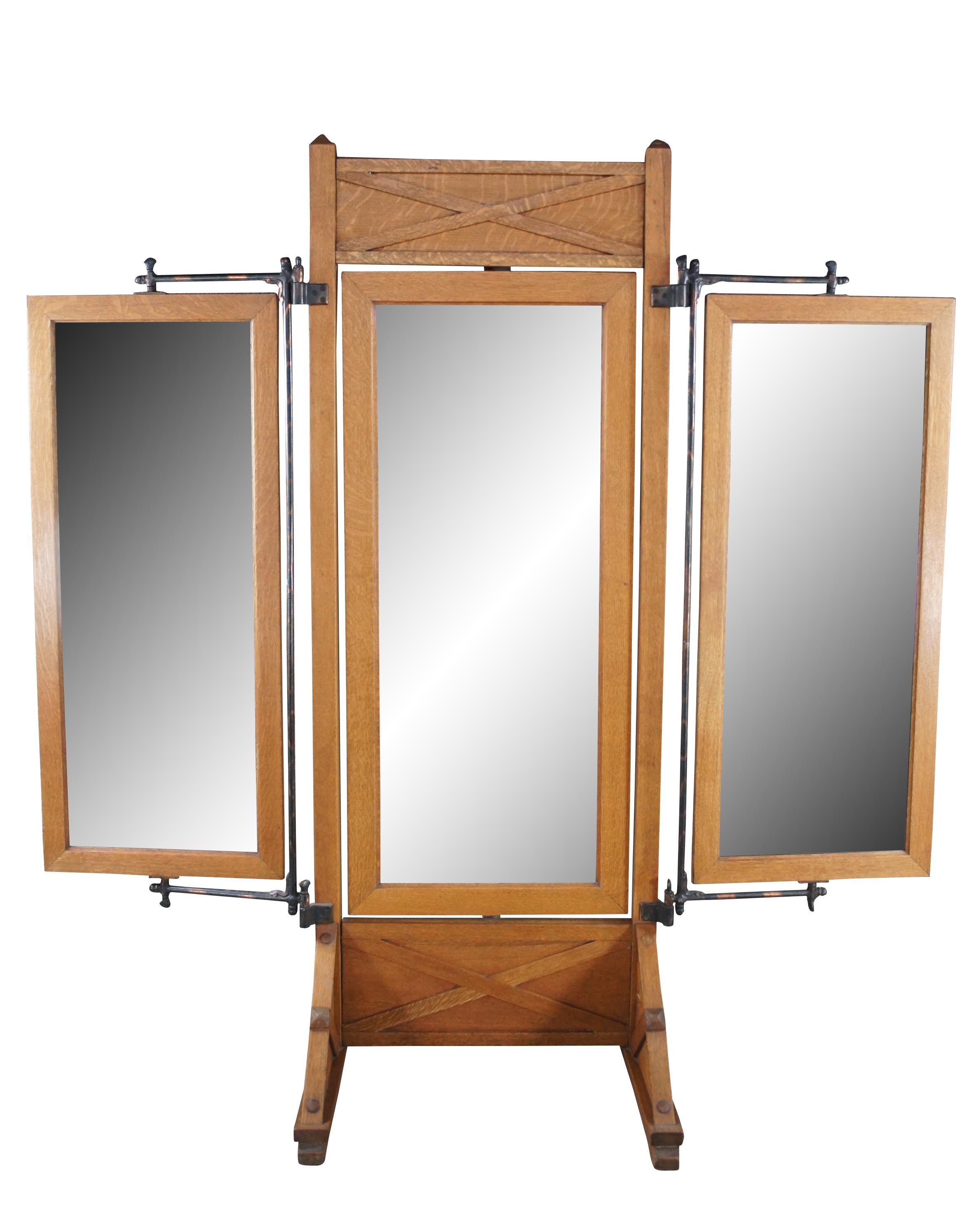 A very large and impressive antique triple cheval tailor / Haberdashers dressing mirror.  Made of quartersawn oak featuring mission styling with unique trifold pivoting design.

Dimensions:
84