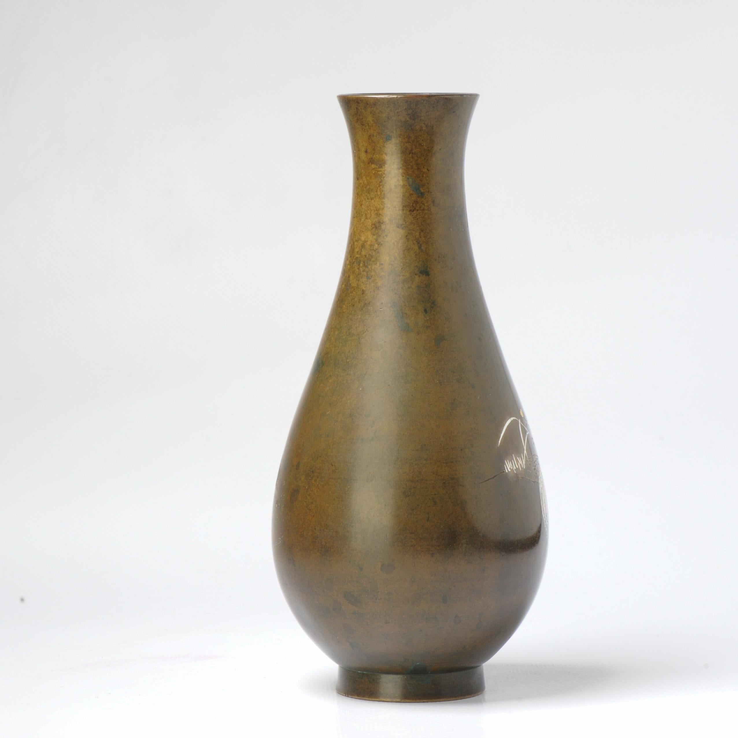 Interesting and finely made mixed metal shibuichi vase. Very cool and of high quality.

Scene of a Rooster and a chicken in a floral garden.

Additional information:
Material: Bronze & Cloisonne
Region of Origin: Japan
Period: 19th century Meiji