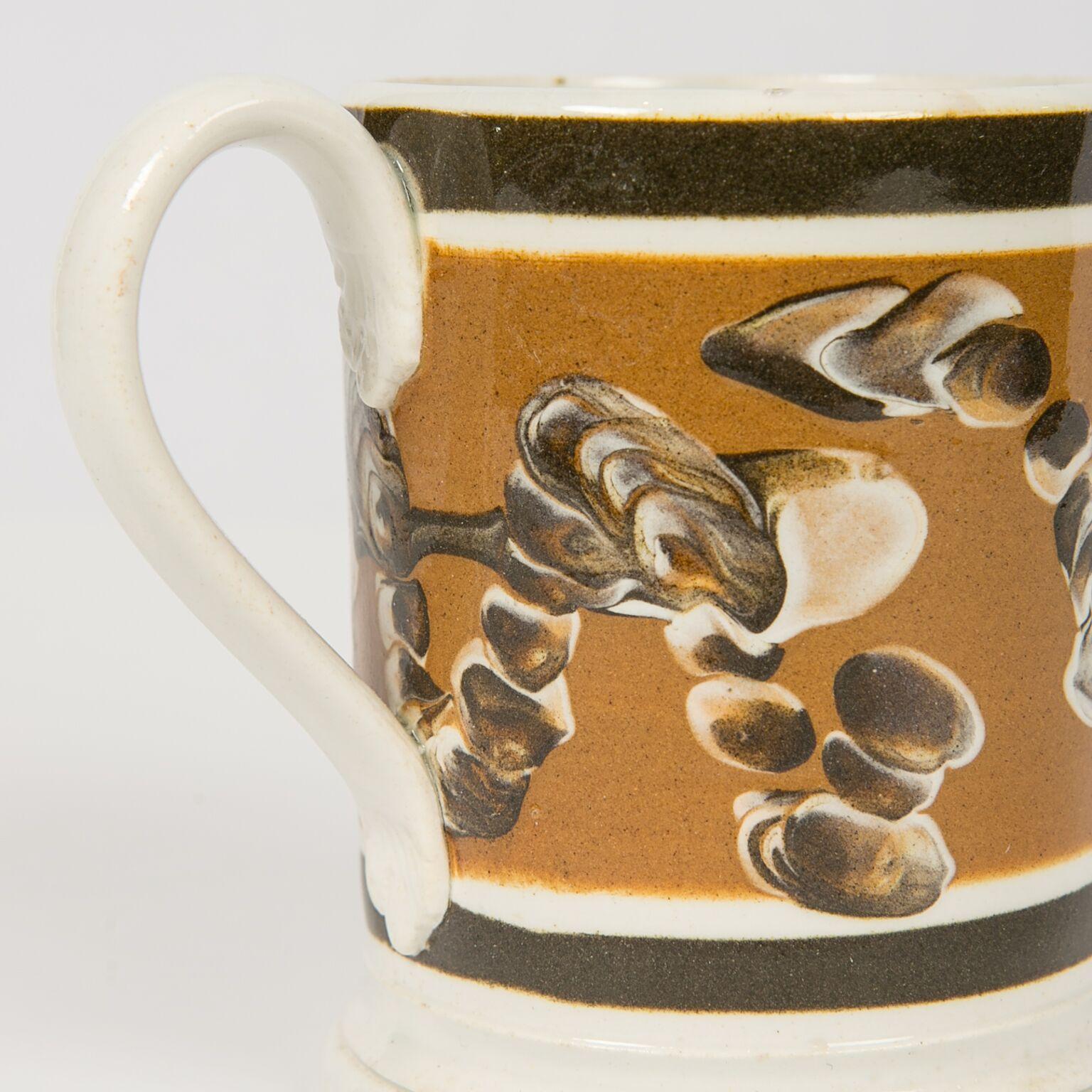 Every piece of Mochaware is unique. Decorated with a three color cable pattern of dark brown, light brown, and white slip this mug is a small gem! Made in England circa 1820 it would have been turned on a lathe. The turner decorated the mug with