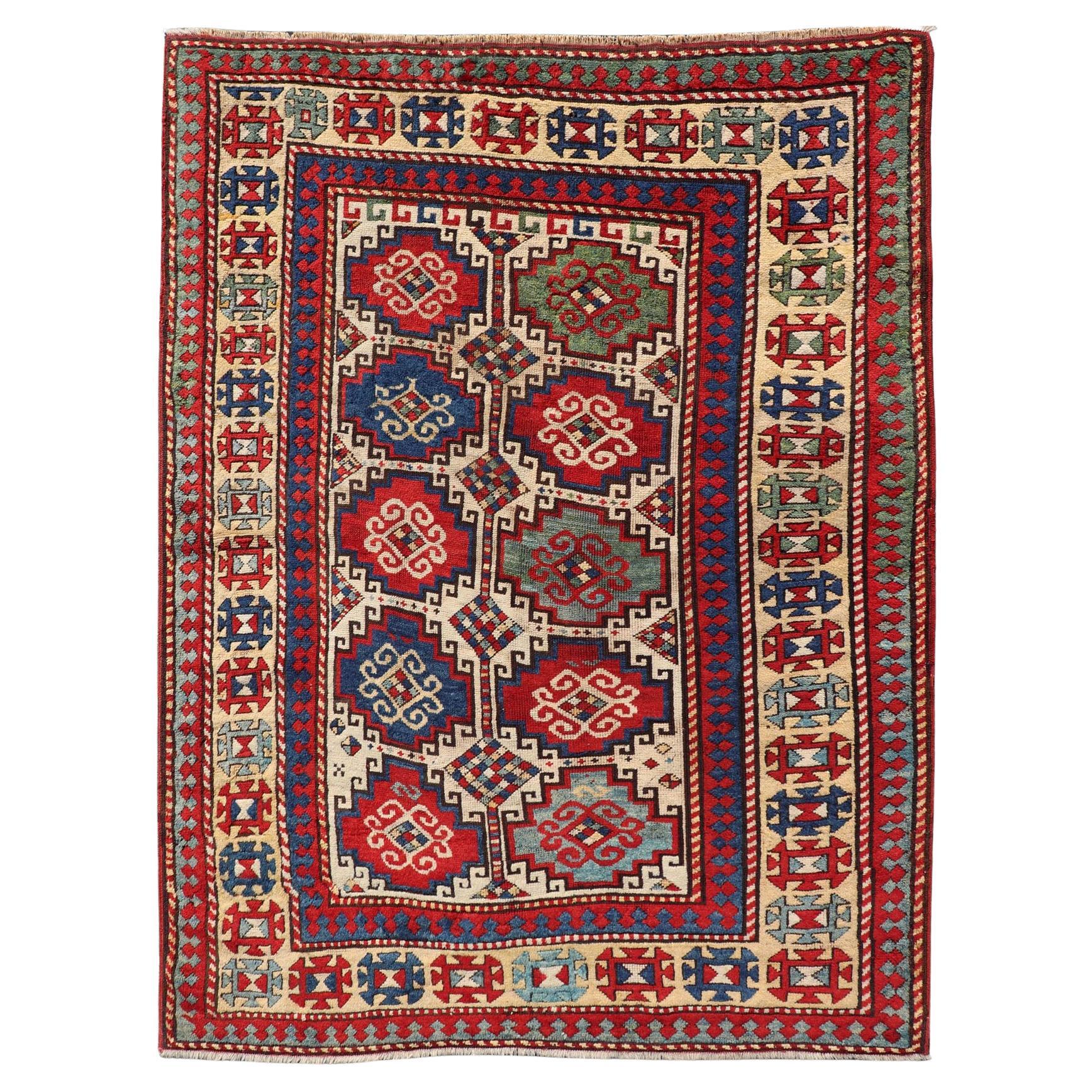 Measures: 4'6 x 6'0 
Antique Moghan Caucasian Kazak Rug Showcasing Bold Geometric Medallions 4'6 x 6'0. Keivan Woven Arts/ rug/X23-1202-172, country of origin / type: Caucasus / Kazak, circa 1875. 
This antique Caucasian Kazak rug features a