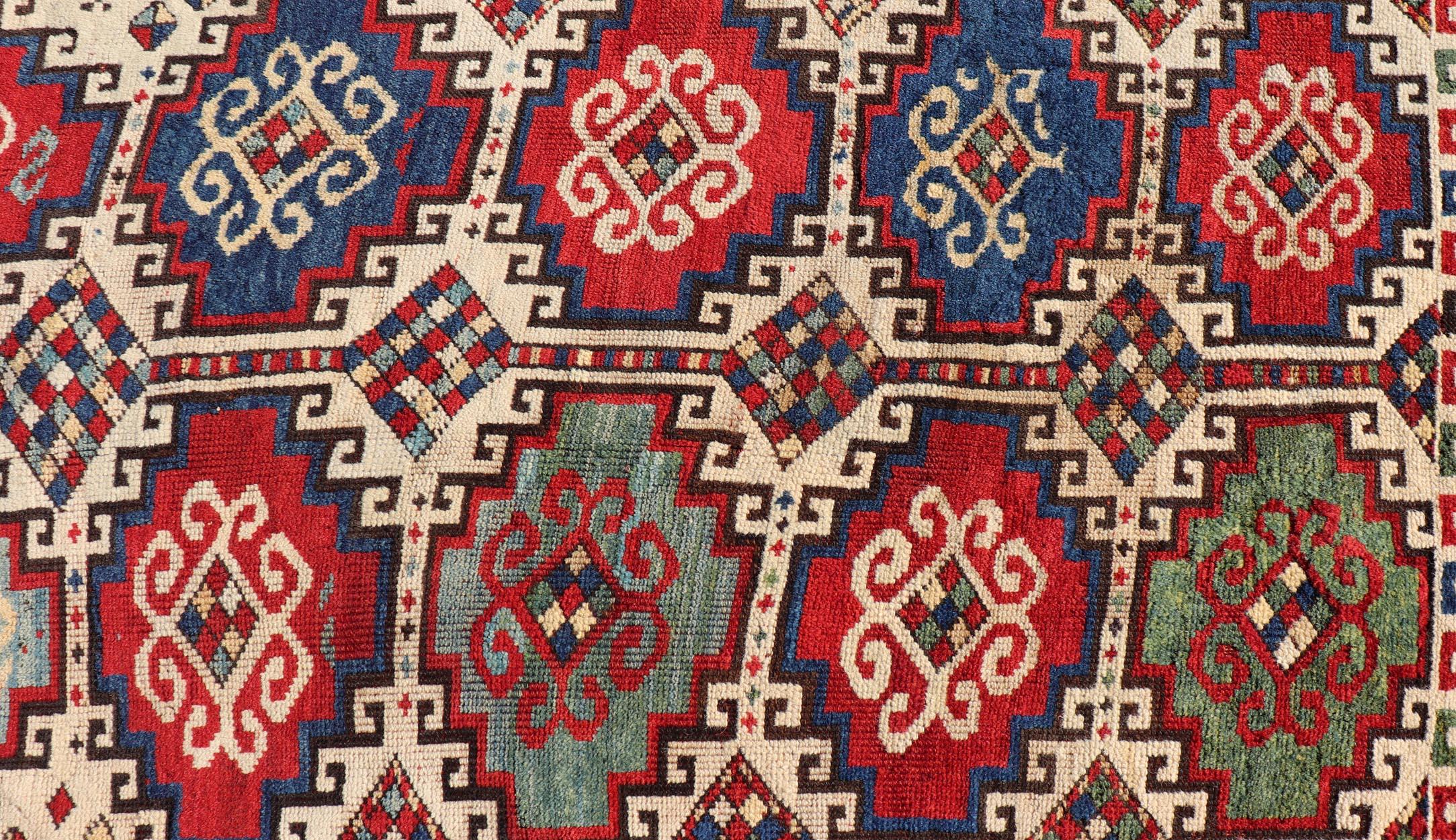 Caucasian Antique Moghan Kazak Rug Showcasing Bold Geometric Medallions 4'6 x 6' For Sale