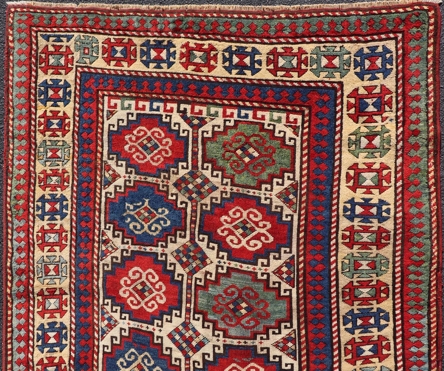 Hand-Knotted Antique Moghan Kazak Rug Showcasing Bold Geometric Medallions 4'6 x 6' For Sale