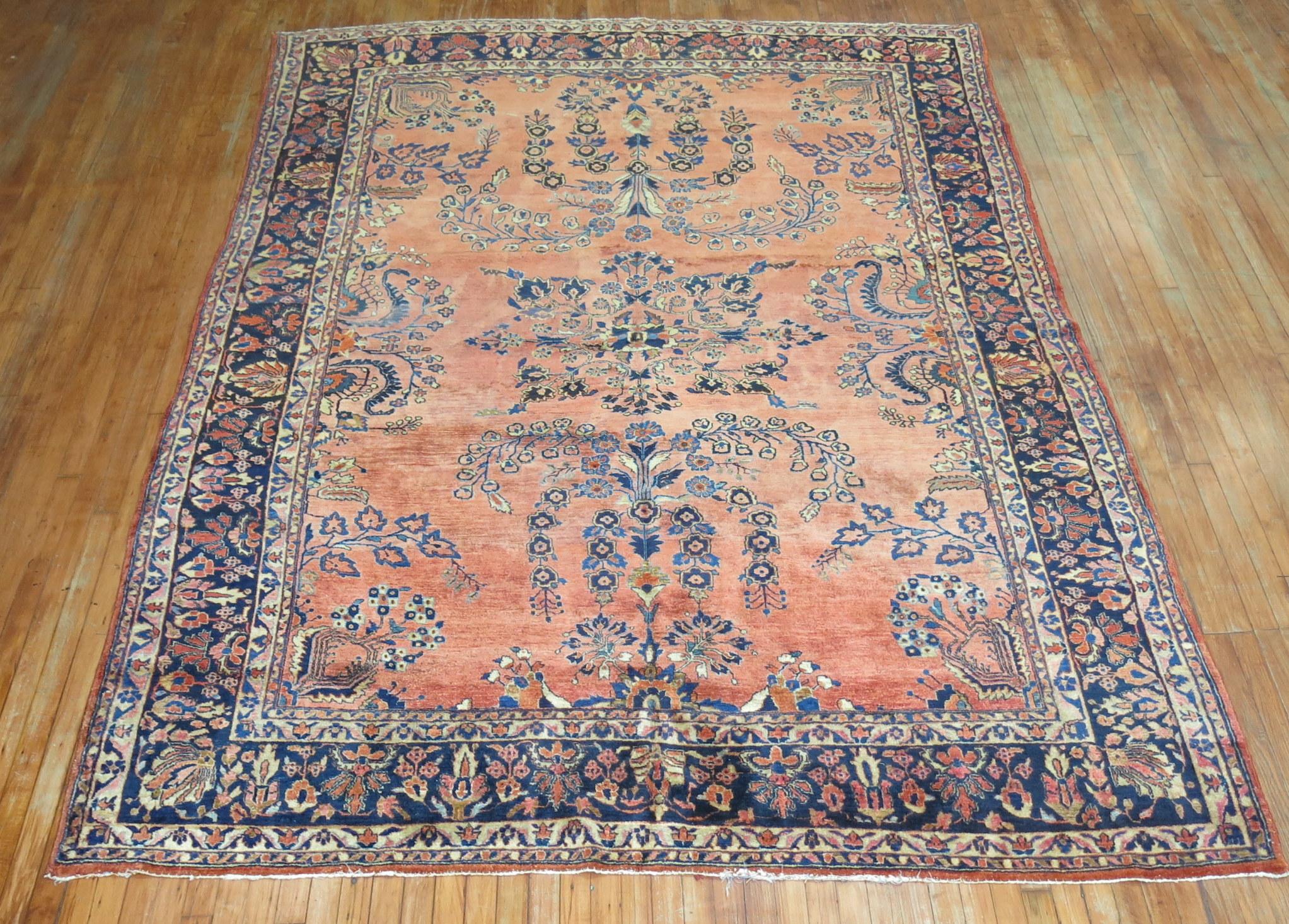 Stunning early 20th century Persian Sarouk Mohajeran Rug.

Before the 1920s the Sarouk design was the most popular of Persian rugs worldwide. Most of them consist of deep red fields with navy borders. Rarely are they found in inverse colors like