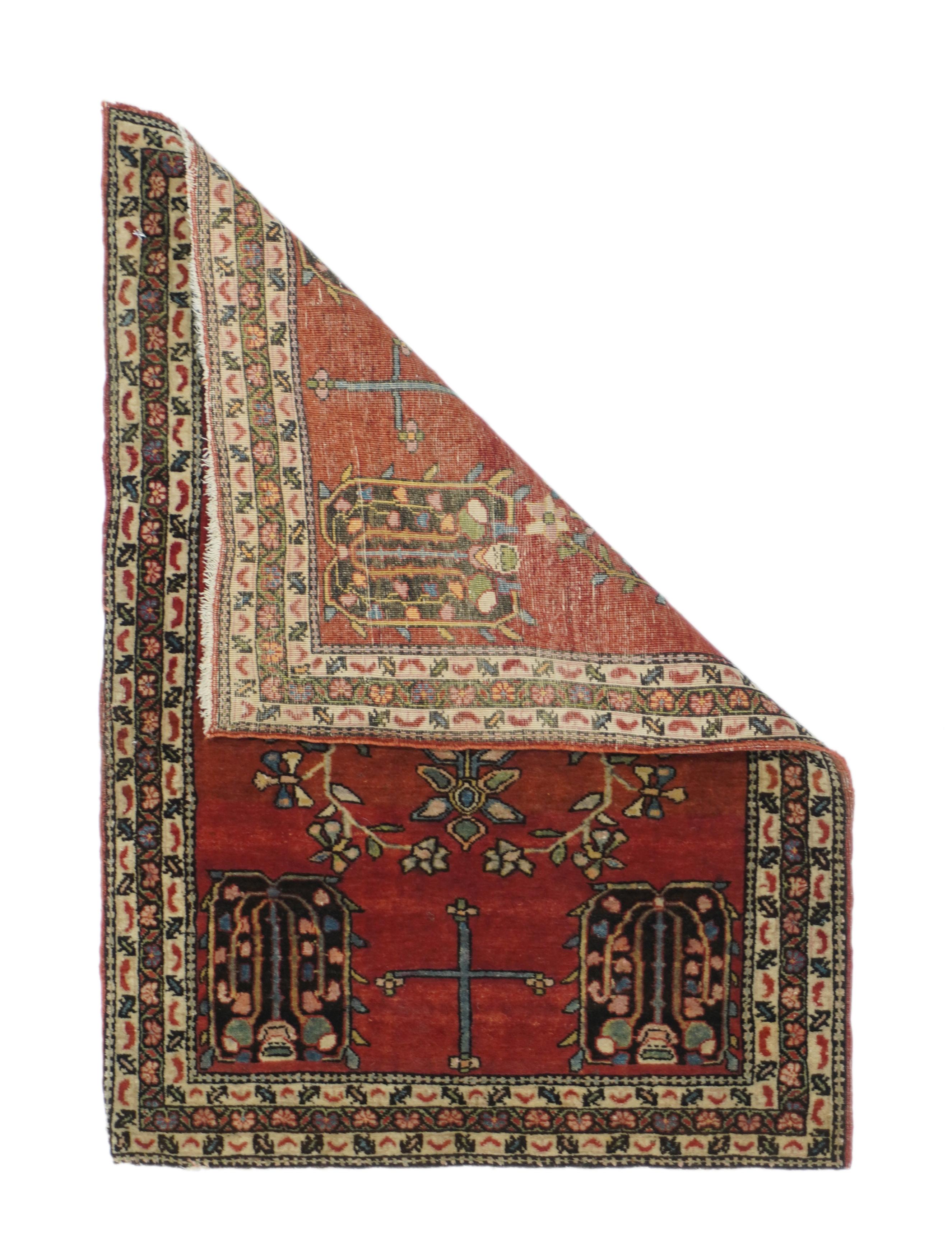 Antique Mohajeran Sarouk rug 1'10'' x 2'9''. This well-woven west Persian village ruglet presents a crimson red field with navy weeping willow and vase motives, and a slender central axial pole with attached and adjacent floral sprays. Reversing fan