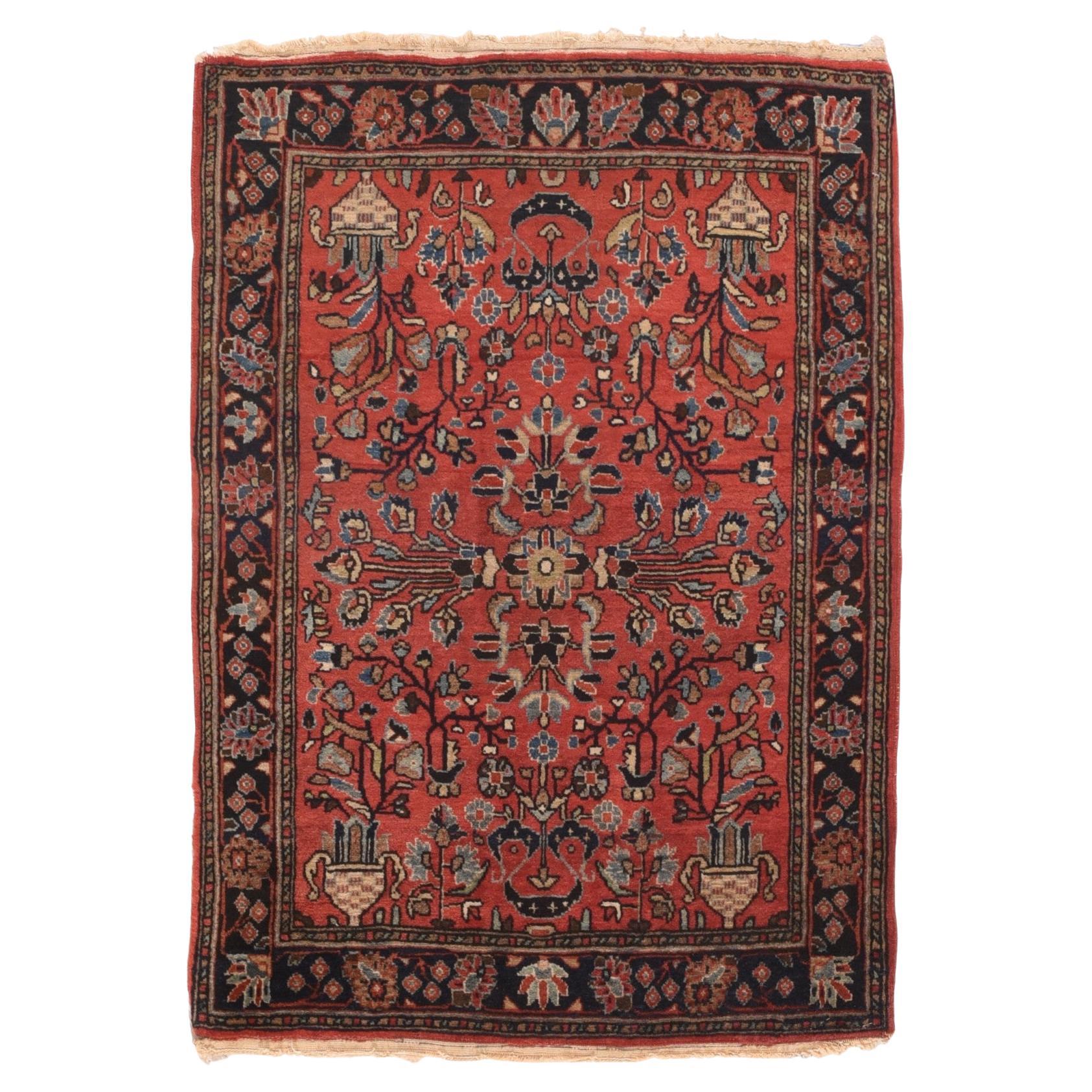 Antique Mohajeran Sarouk Rug 2' x 3'. This relatively modern West Persian village scatter with an urban texture, shows a red-rose field with chequered corner vases and a central rosette. Green, medium blue, navy, straw and ecru-beige accent the