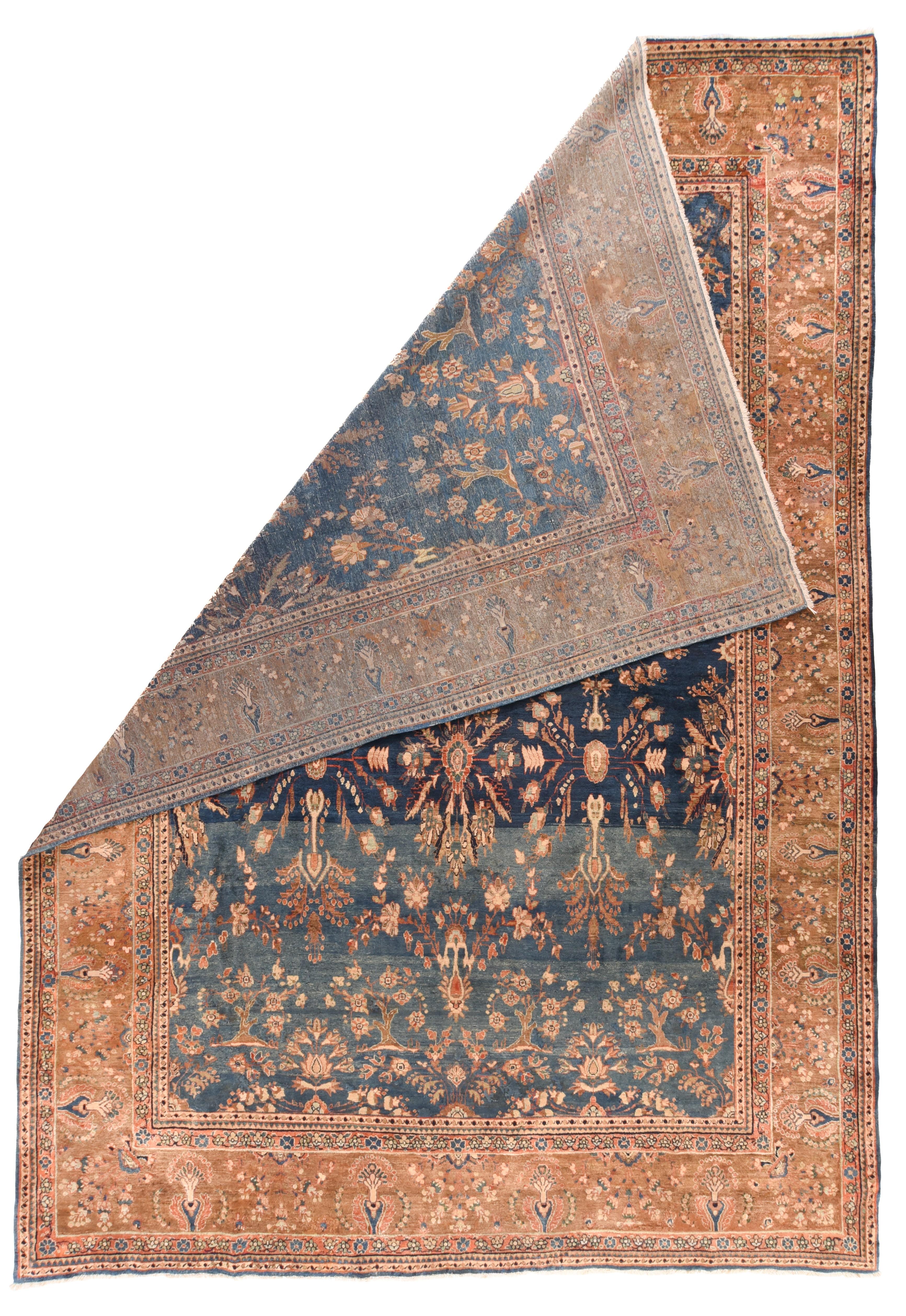 Antique Mohajeran Sarouk rug, measures : 8'7'' x 12'5''. Iconic 30s piece with a medium red field decorated by rosettes, palmettes and various leaves, and centred by a navy pendanted medallion. Navy and green corners with tilted vases. Navy border