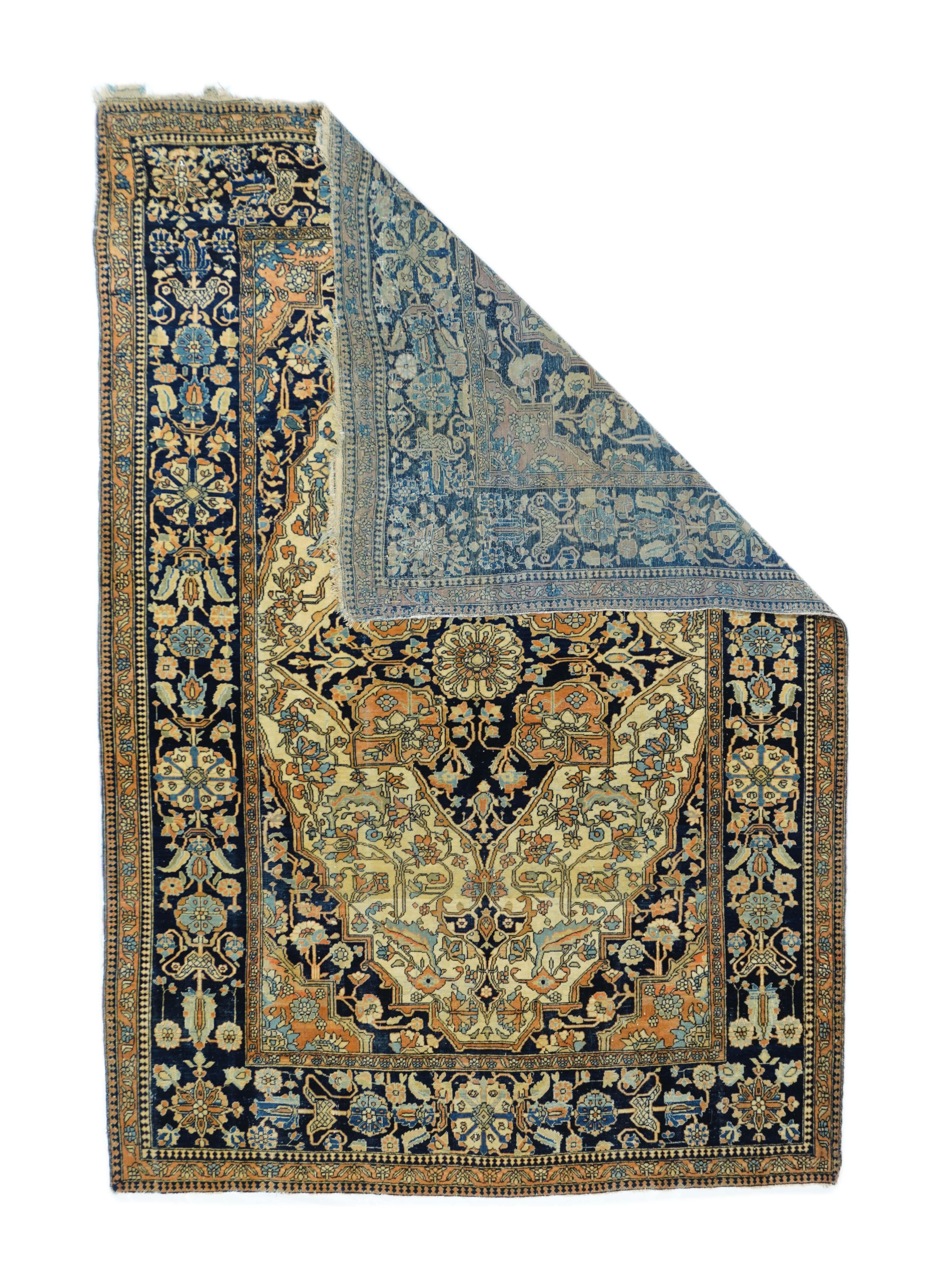 Antique Mohtasham Kashan rug 4'4'' x 6'3''. The oval cream field shows a navy octogramme medallion with rust palmette radiations, together with navy and rust corners. Stained glass drawing of serrated leaves, palmettes and broken stems. Navy borders