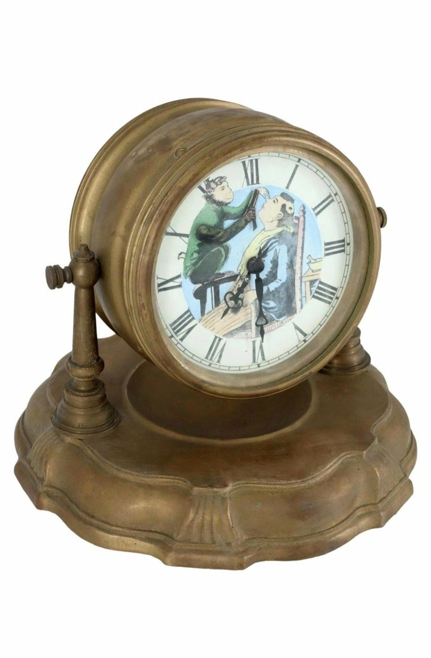 A most amusing late 19th / early 20th century animated novelty clock, depicting monkey barber giving a haircut with disastrous results.

Art Nouveau period, brass-cased, gimbal supported case hangs above scalloped round base molded with vide poche,