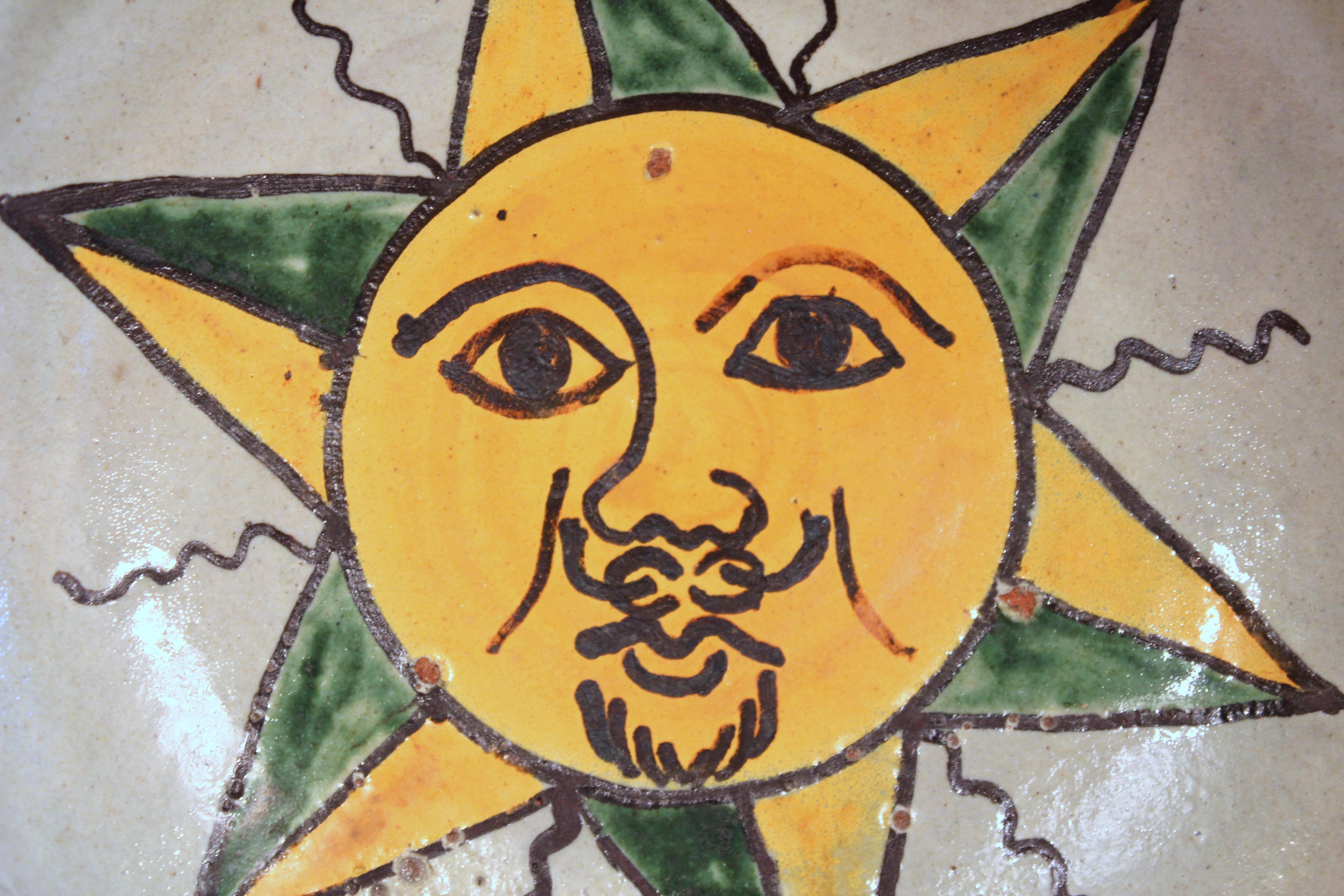 pottery sun face