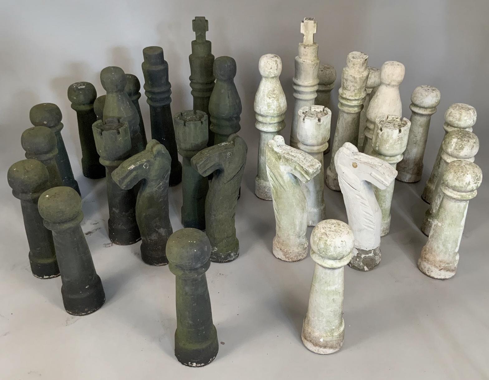 A very impressive large scale cast concrete chess set, complete with 36 pieces, half black and half white. In their original finish with aged patina.
