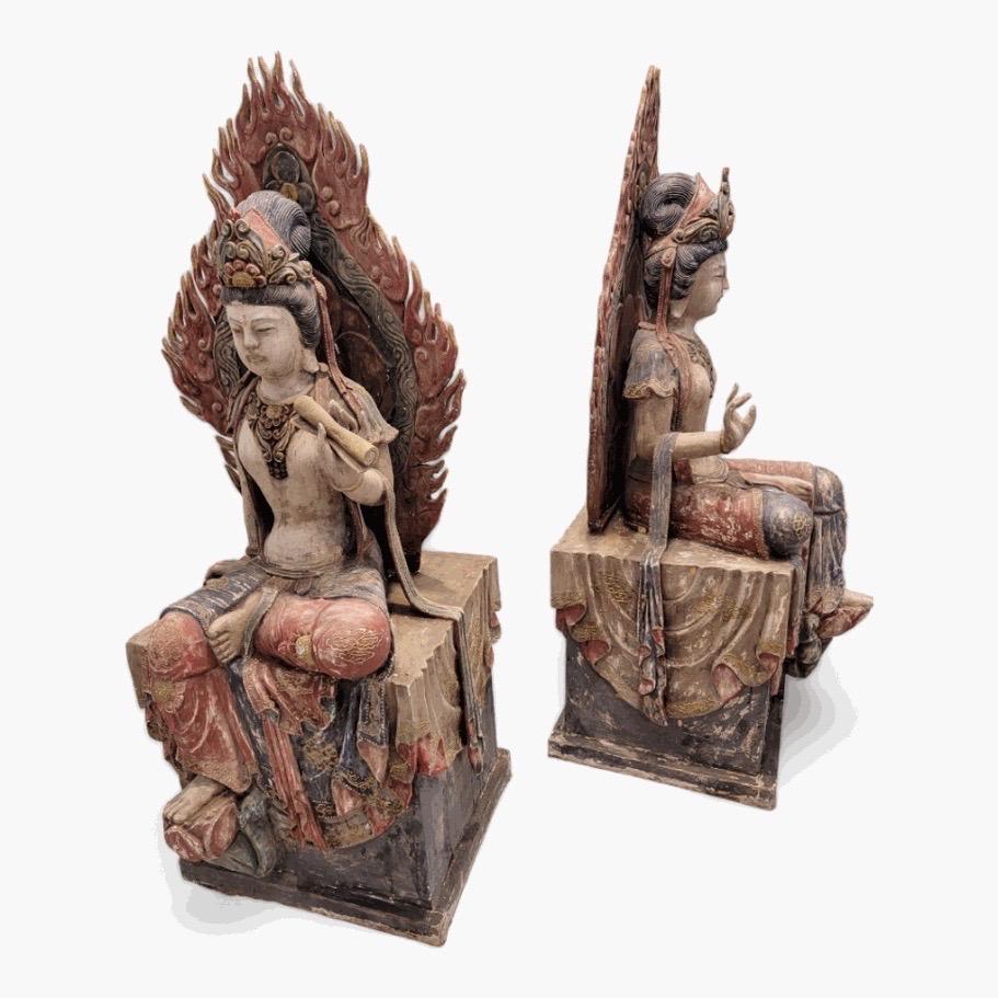 Antique Monumental Chinese Quan-Yin Sitting Mandorla Carved Polychromed Wood Sculpted Statues - Set of 2

This set of two antique monumental Chinese Quan-Yin sitting mandorla carved polychromed wood sculpted statues is a stunning addition to any
