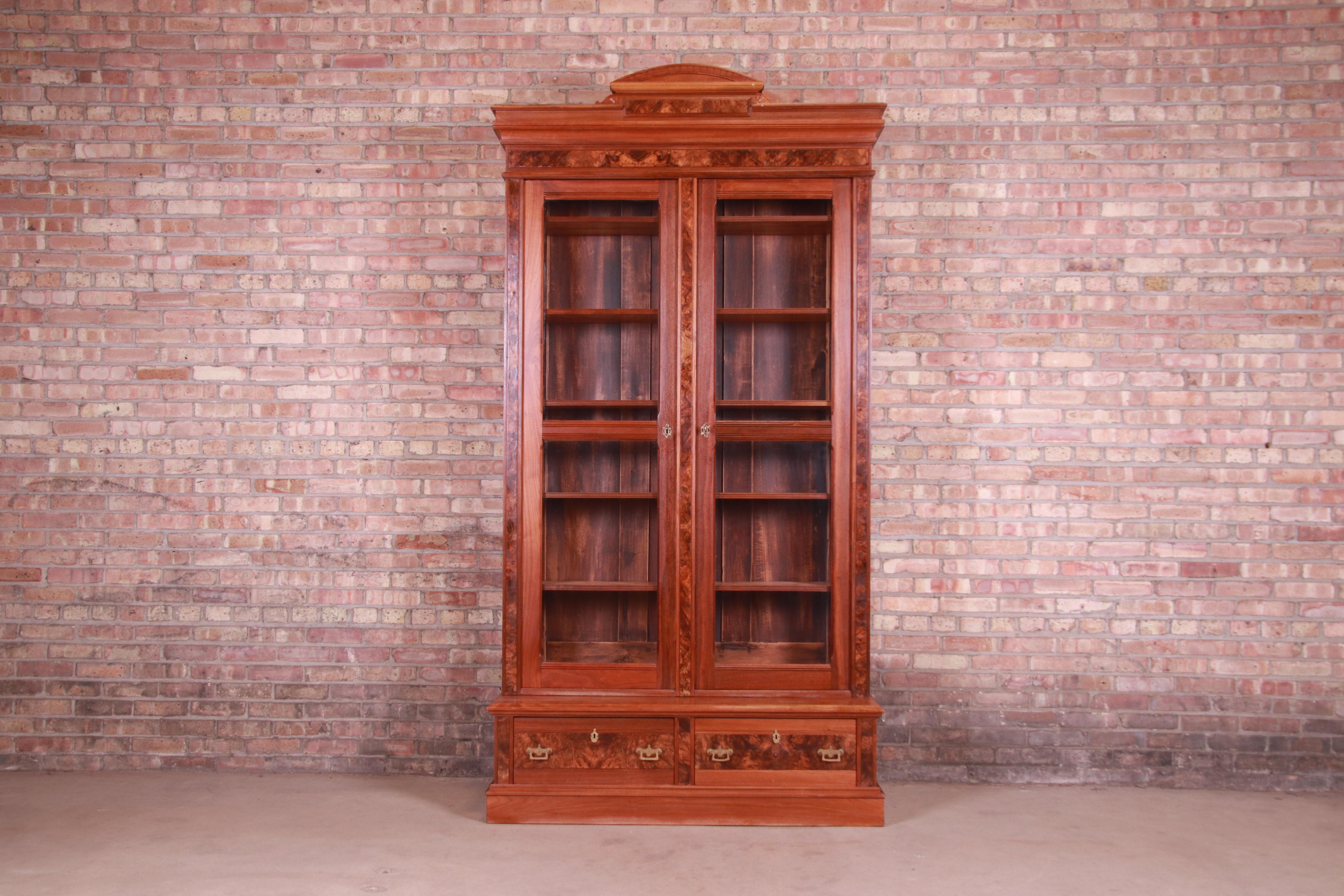 An exceptional antique monumental Eastlake Victorian bookcase

USA, circa 1860s

Carved walnut, with burled walnut front and original brass hardware.

Measures: 50