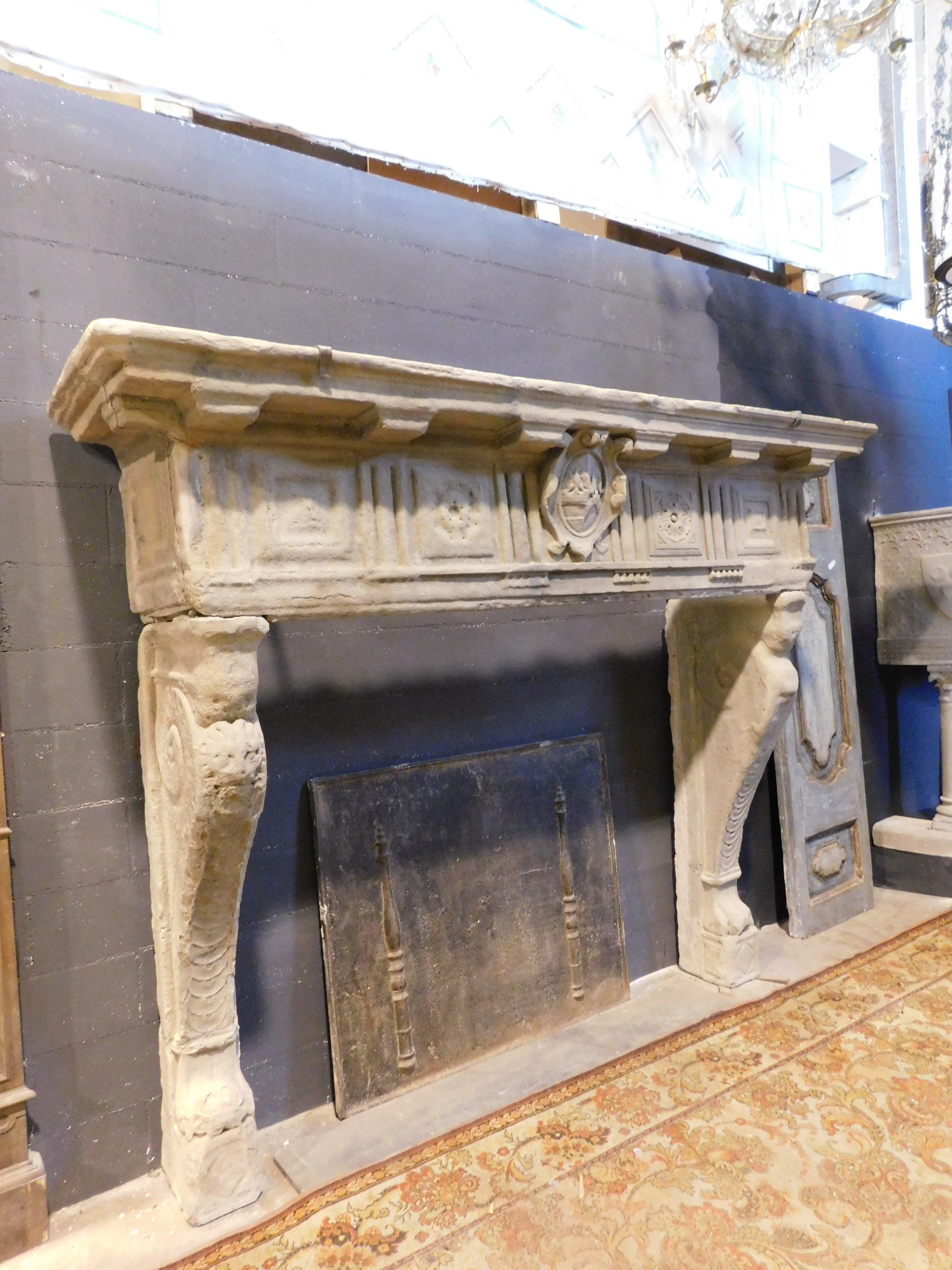 Ancient monumental fireplace, large hand-sculpted mantle with noble coats of arms and caryatids in Serena stone, from Tuscany (Italy), original from the 16th century, the patina and wear certify the originality of more than 500 years of life. It was