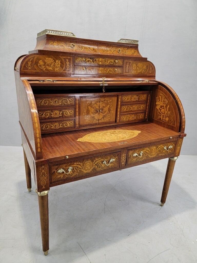 Antique Monumental French Regency Inlaid Brass Mounted Barrel Roll Top Cylinder Barrel Desk

This luxurious antique desk imported from Europe would be a breathtaking and functional furnishing for your office, bedroom, or living room. It has be