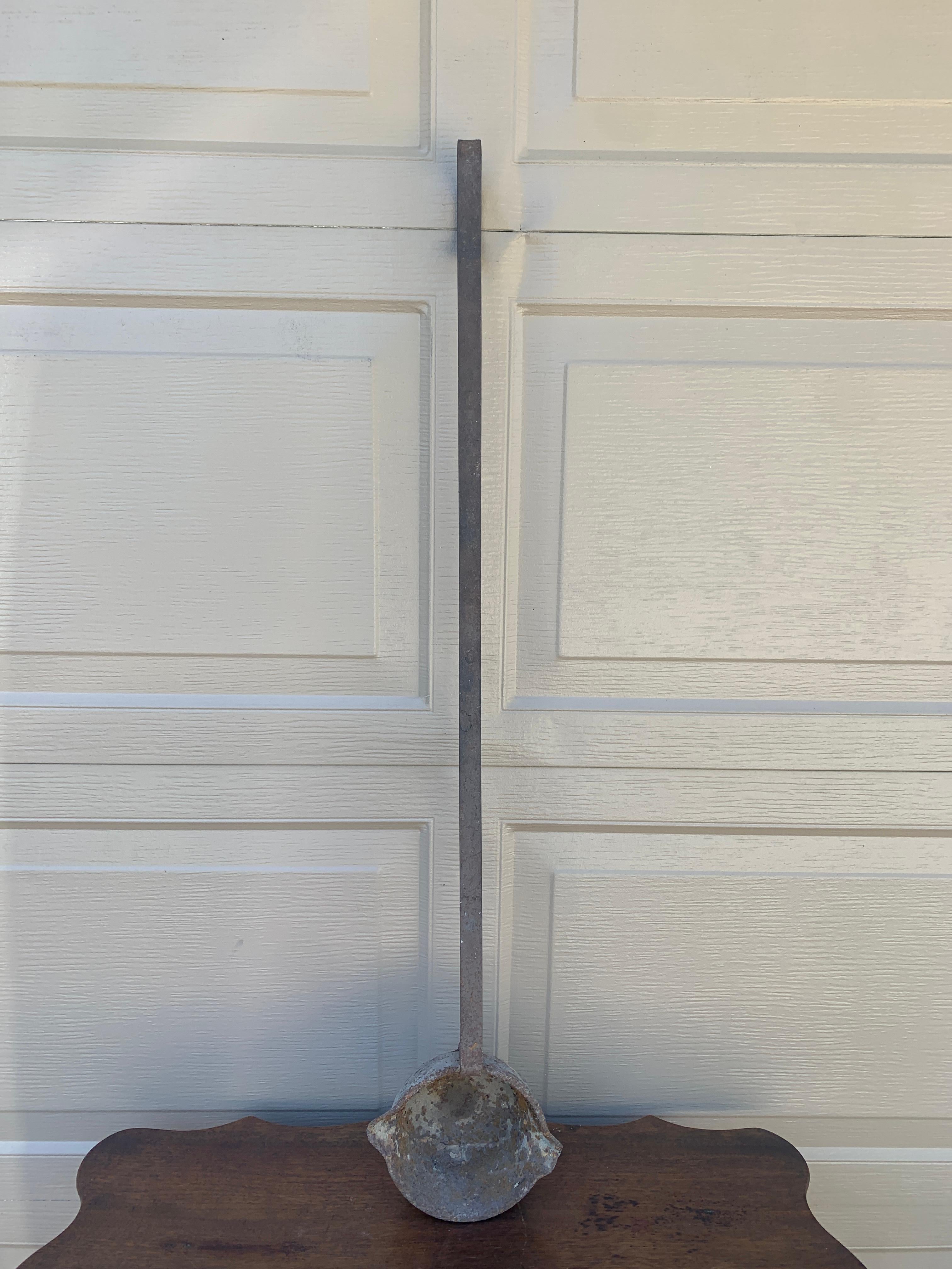 A rare and unique antique rustic industrial iron hand forged commercial ladle. This piece would have been used to prepare large meals in a restaurant, school, or other commercial endeavor. This would be ideal for an installation on a large wall on a