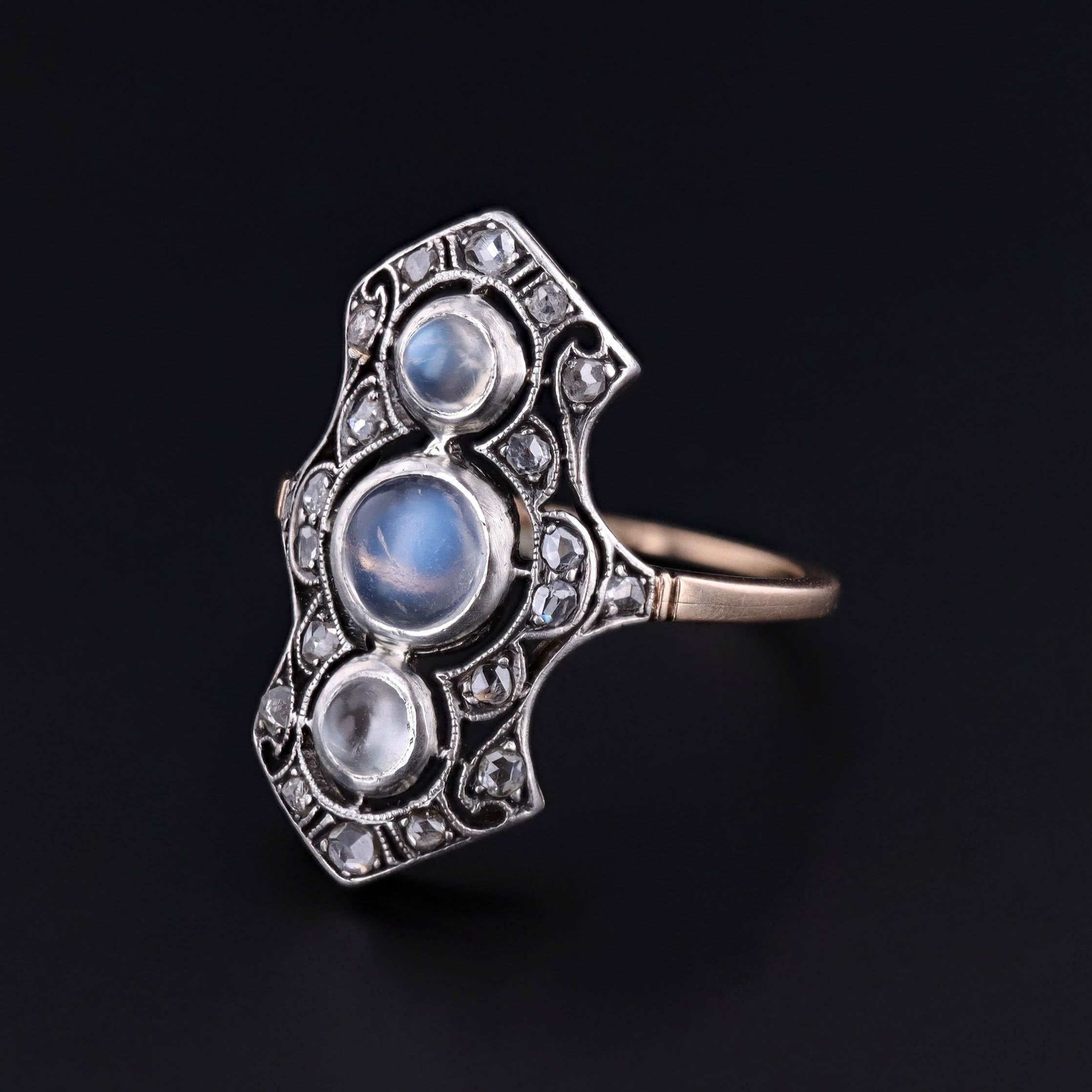 This antique filigree ring (circa 1890) features three orthoclase moonstones with rose cut diamonds, mounted in silver topped 14k gold.

The face of the ring measures 0.9 inches by 0.5 inches wide, and it is in very good condition. It is a size 7,