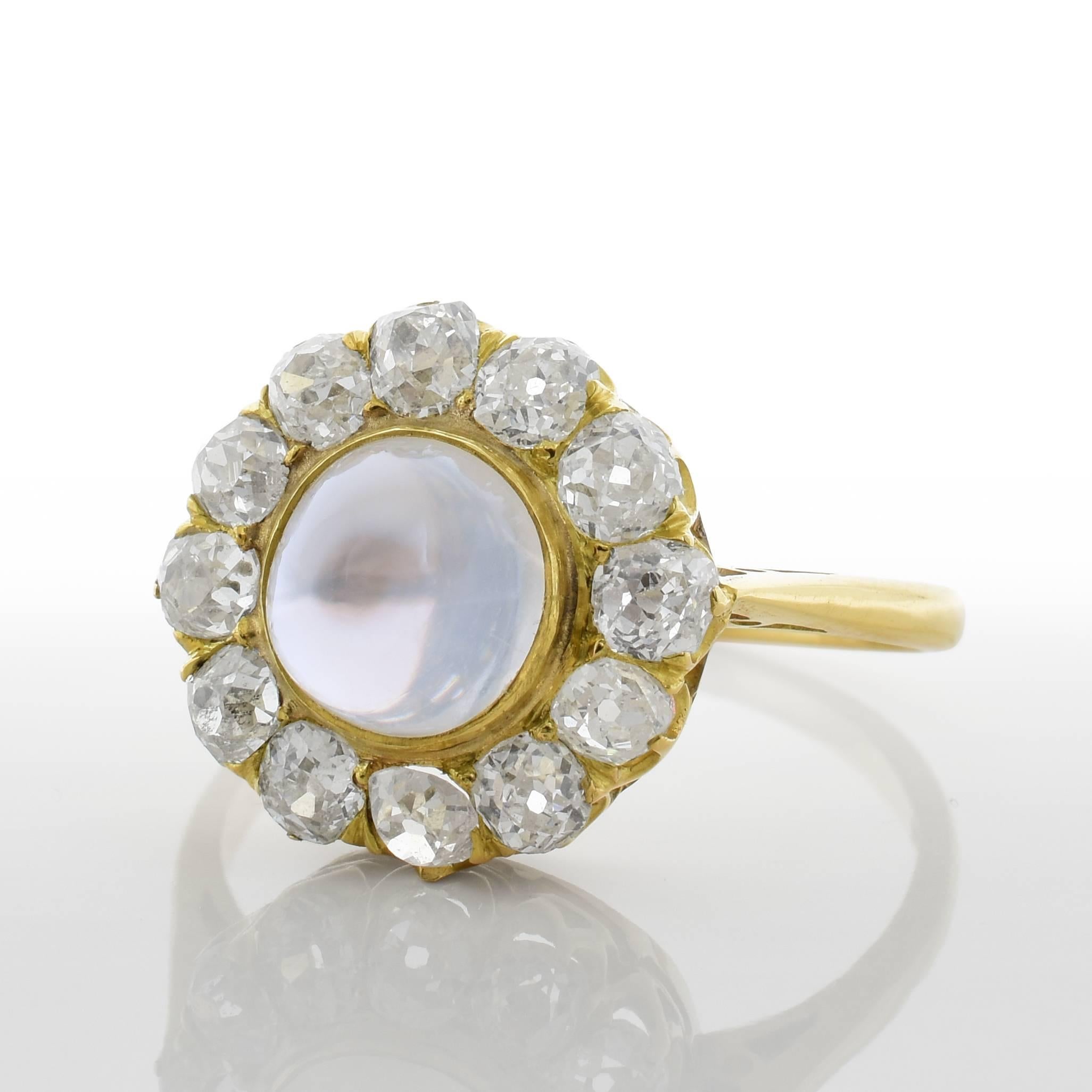 This antique ring features a moonstone center. The moonstone is beautiful light periwinkle. It is surrounded by approximately 1.50 carats of old cut diamonds and set in 18k yellow gold.