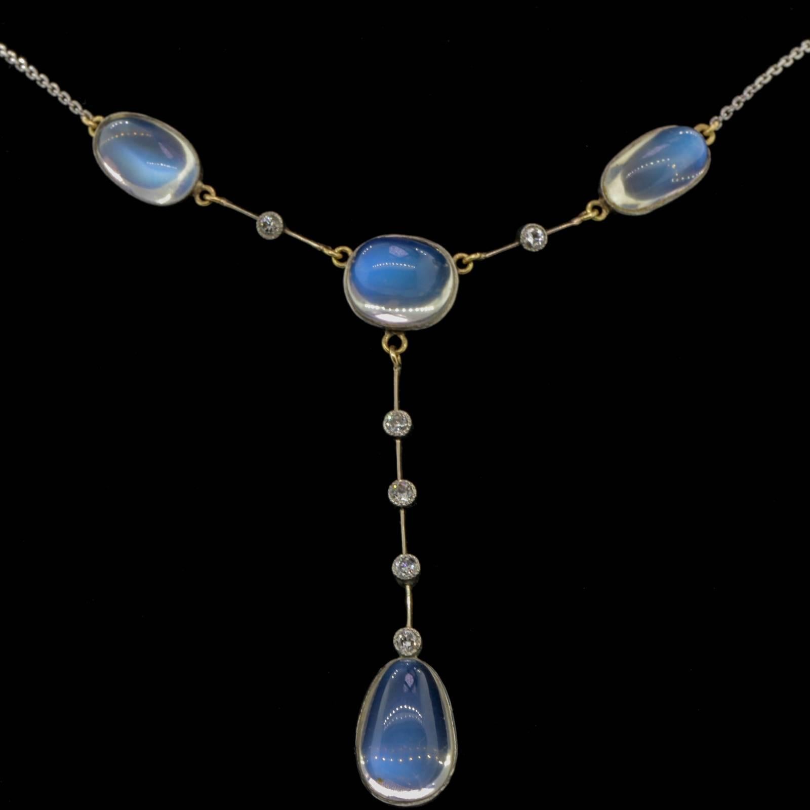 This exquisite antique necklace is fabricated in platinum top 14KT yellow back,accented with three cabochon sugar loaf cut Moonstones dangling a tear shape cabochon Moonstone.  The Moonstones are interspersed with six bezel set Old European Cut