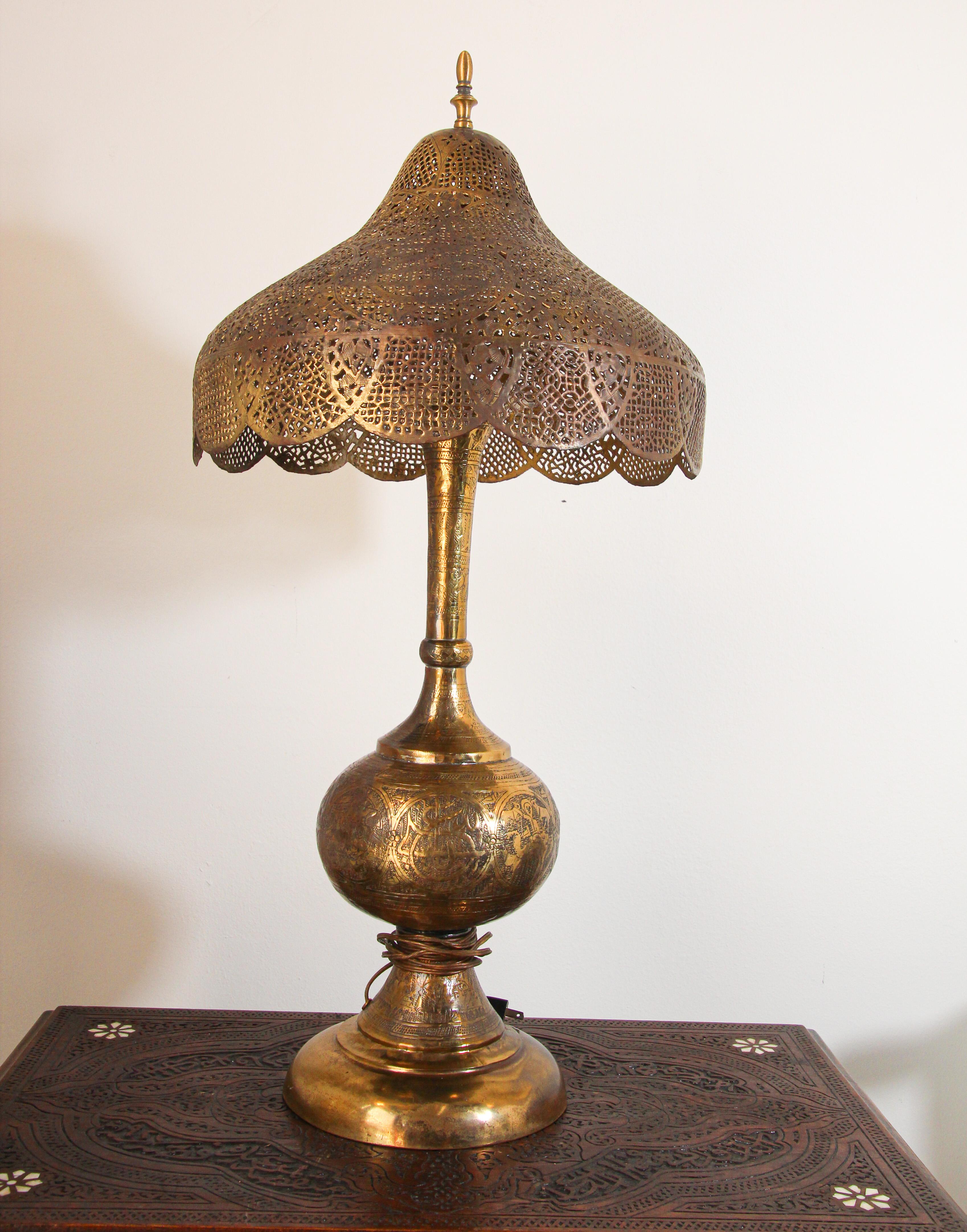 Antique fine Middle Eastern Moorish revival brass table lamp with Arabic calligraphy writing.
Moorish, Syrian style brass table lamp with hammered brass with fine Islamic designs and Egyptian figure and animals. Hand-cut filigree shade.
Brass