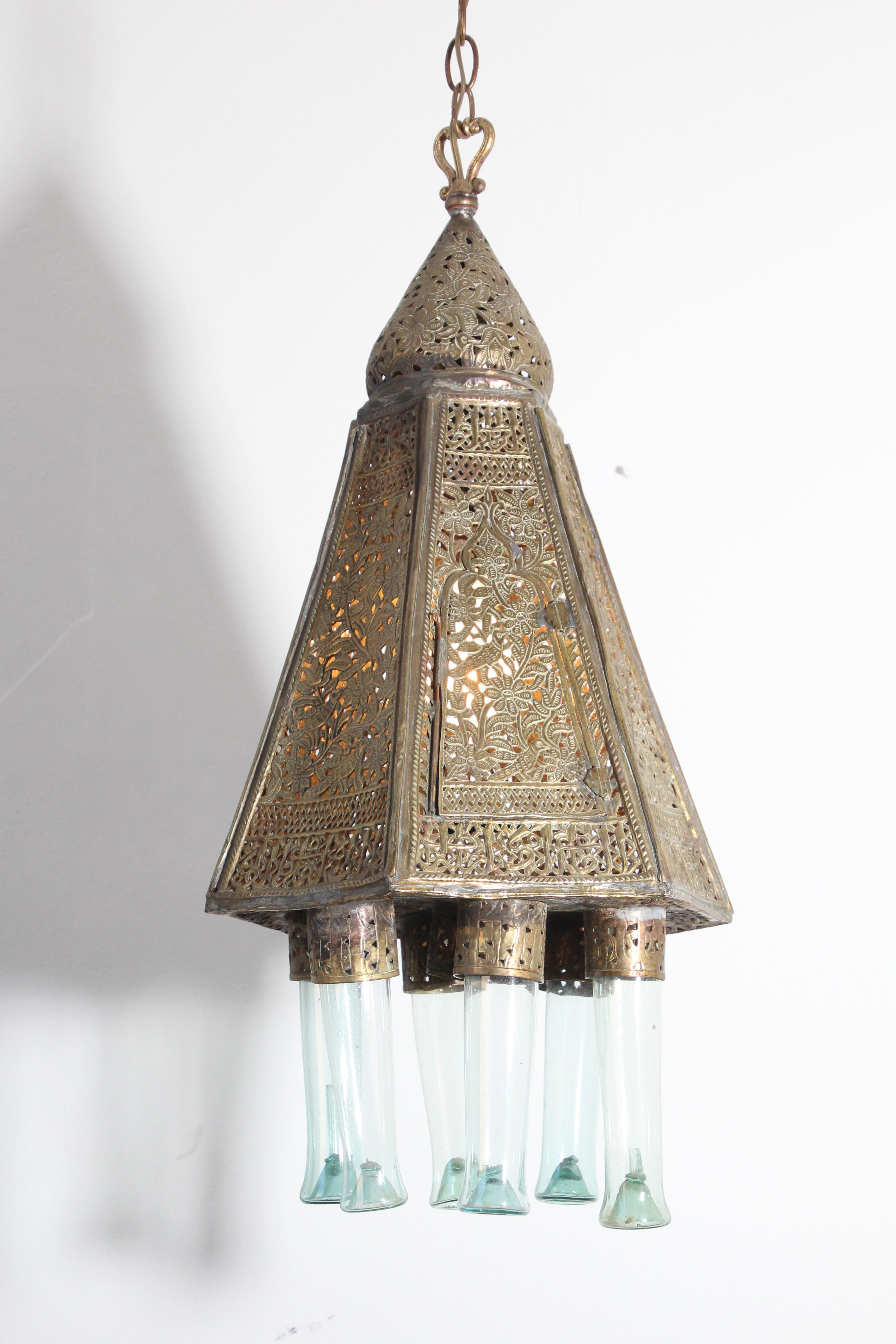 Antique Moorish brass Turkish palace lamp.
Moorish style brass antique pendant with 6 handblown Bohemian glass.
The brass is delicately hand-hammered and chiseled into Arabic Islamic calligraphy writing designs and floral patterns on six sides,