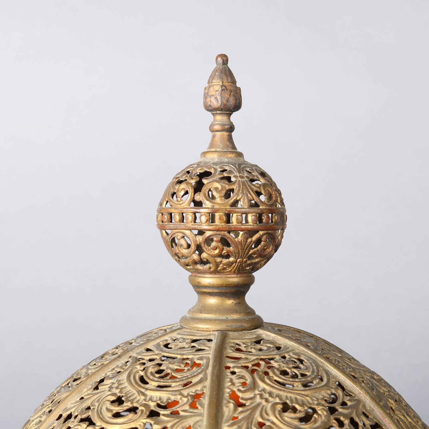 Antique Moroccan dome table lamp features Moorish Mosque dome form with scroll, foliate and gadroon reticulated shade having jewelled accents, circa 1930

Measures: 11