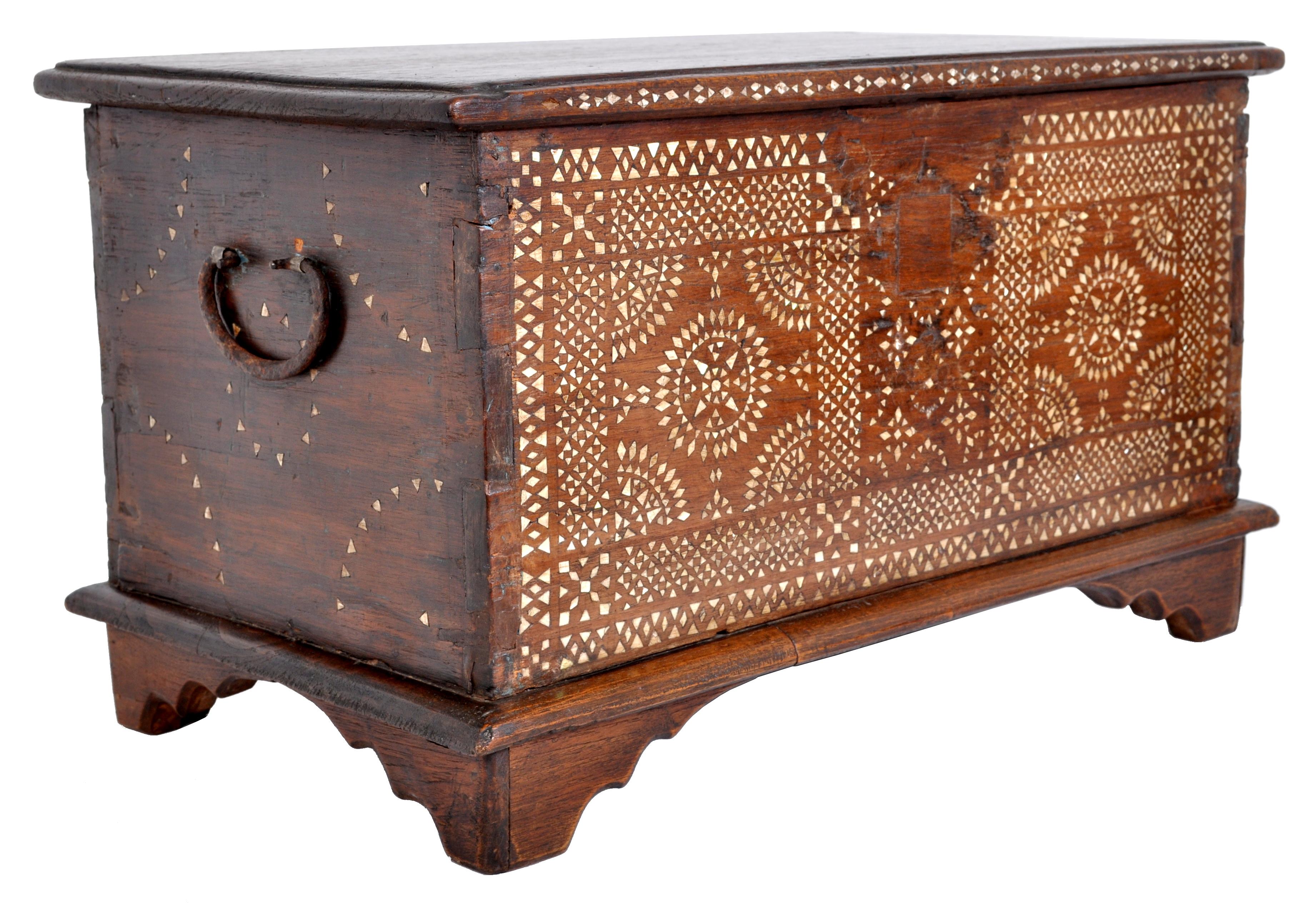 A good antique Moroccan Islamic box inlaid with mother of pearl, circa 1900. The casket having a hinged lid enclosing a storage area wth a single lidded till. The trunk is profusely inlaid with mother of pearl in a geometric design and has iron